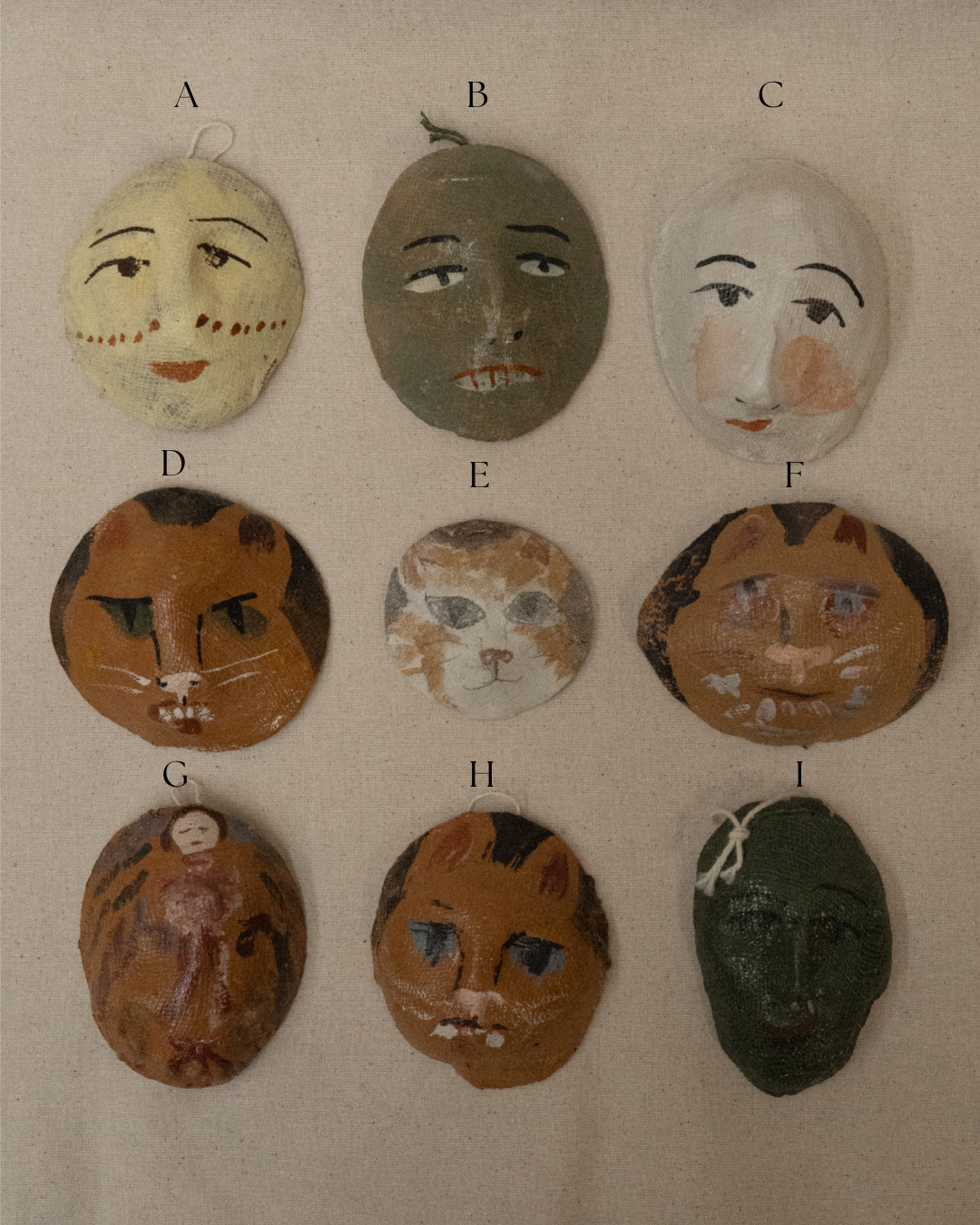 Painted face masks wall hanging