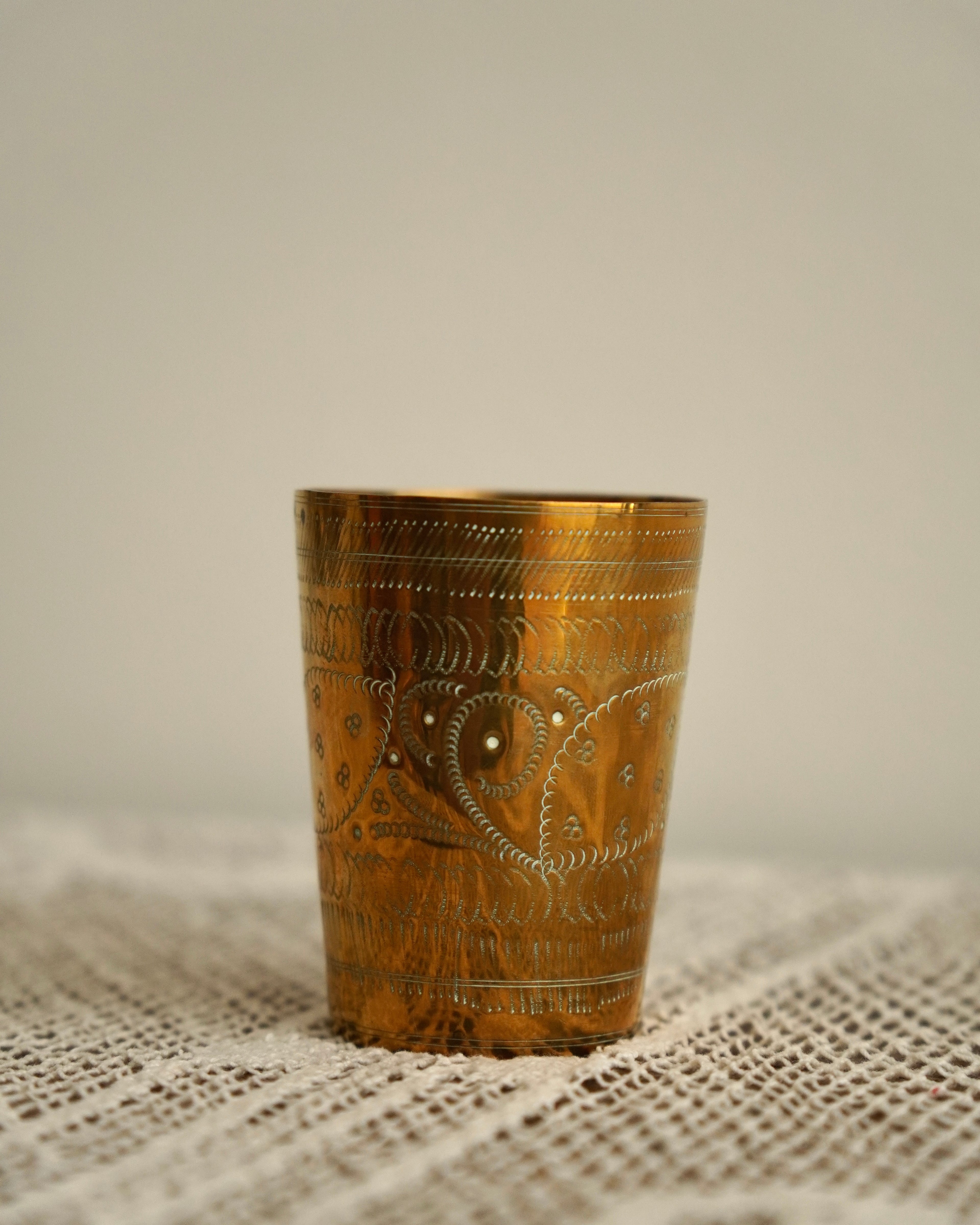 Brass cup with engravings