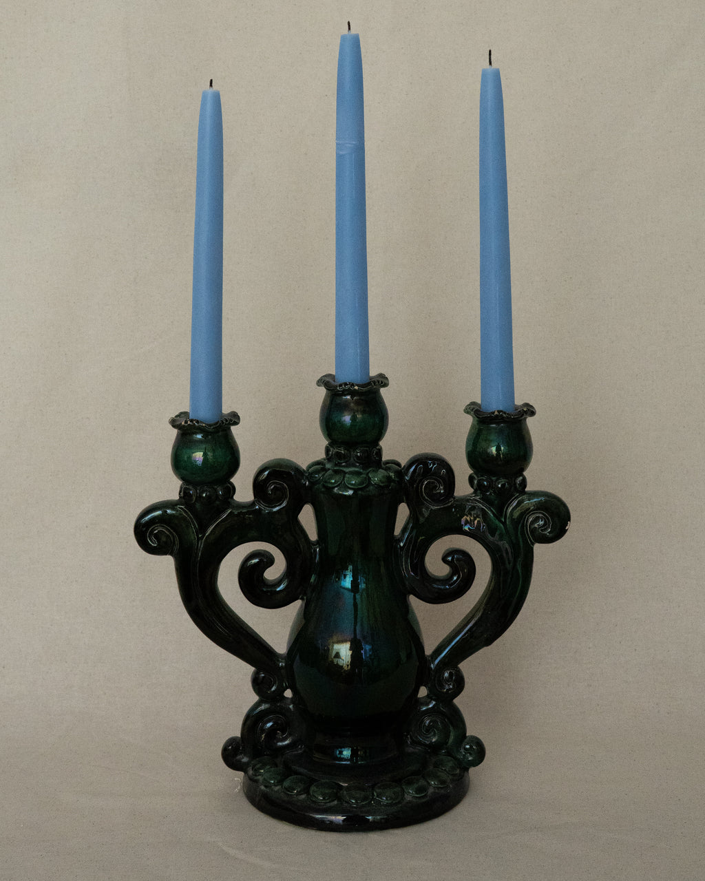 Green ceramic candelabra with rainbow lustre glaze, holds 3