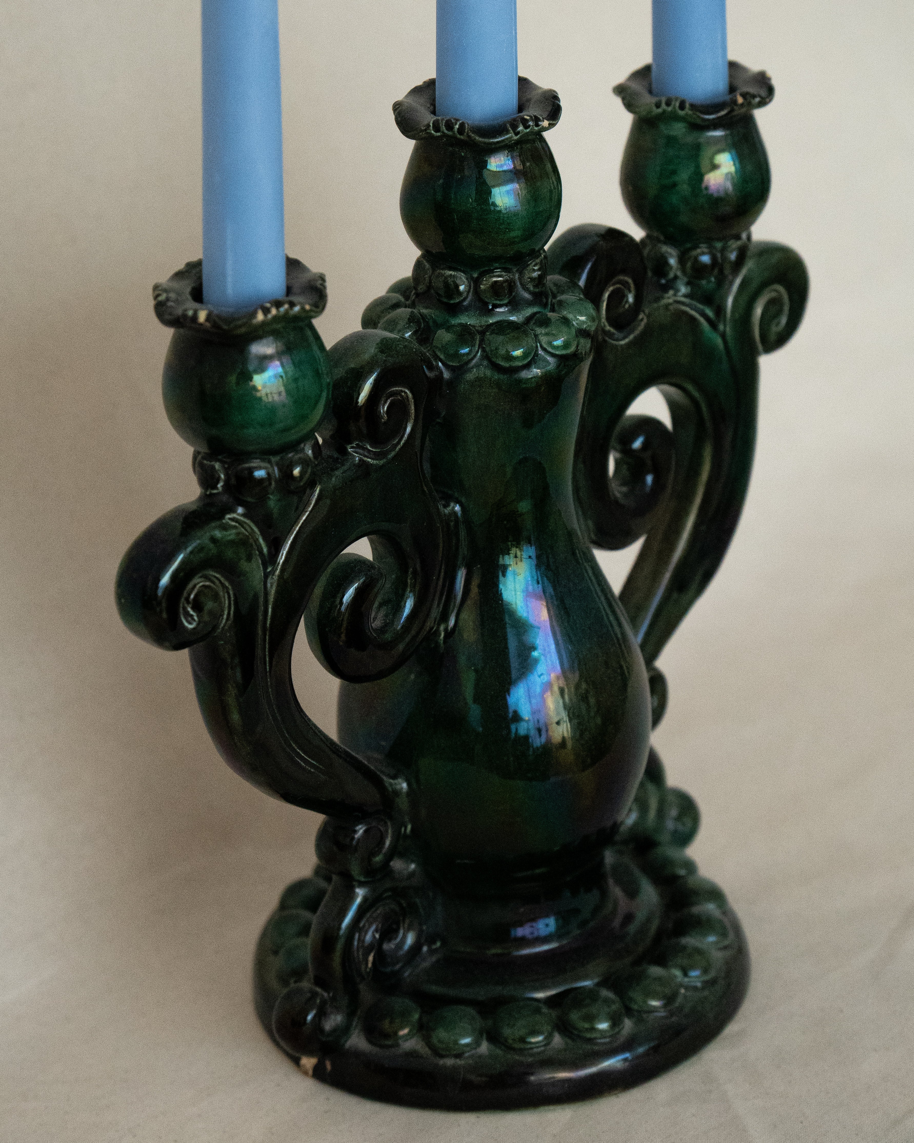 Green ceramic candelabra with rainbow lustre glaze, holds 3