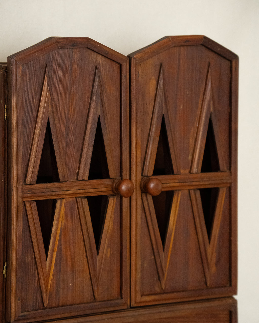 Wooden gothic style cabinet with shelving, two doors and a drawer
