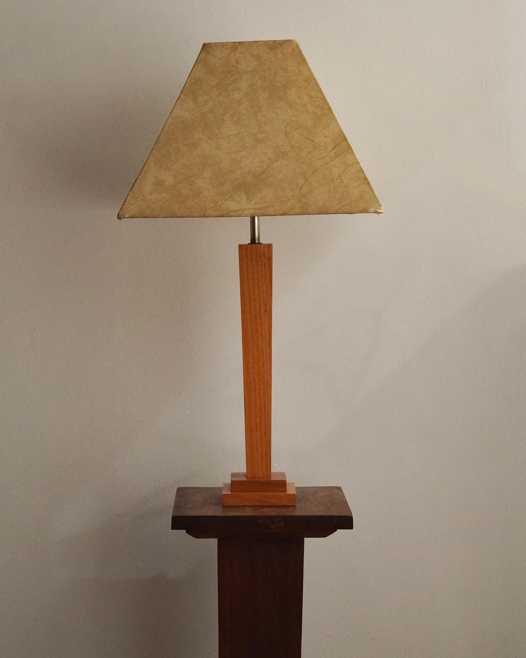 Art deco style lamp with faux leather like lampshade, tapered body square stepped base