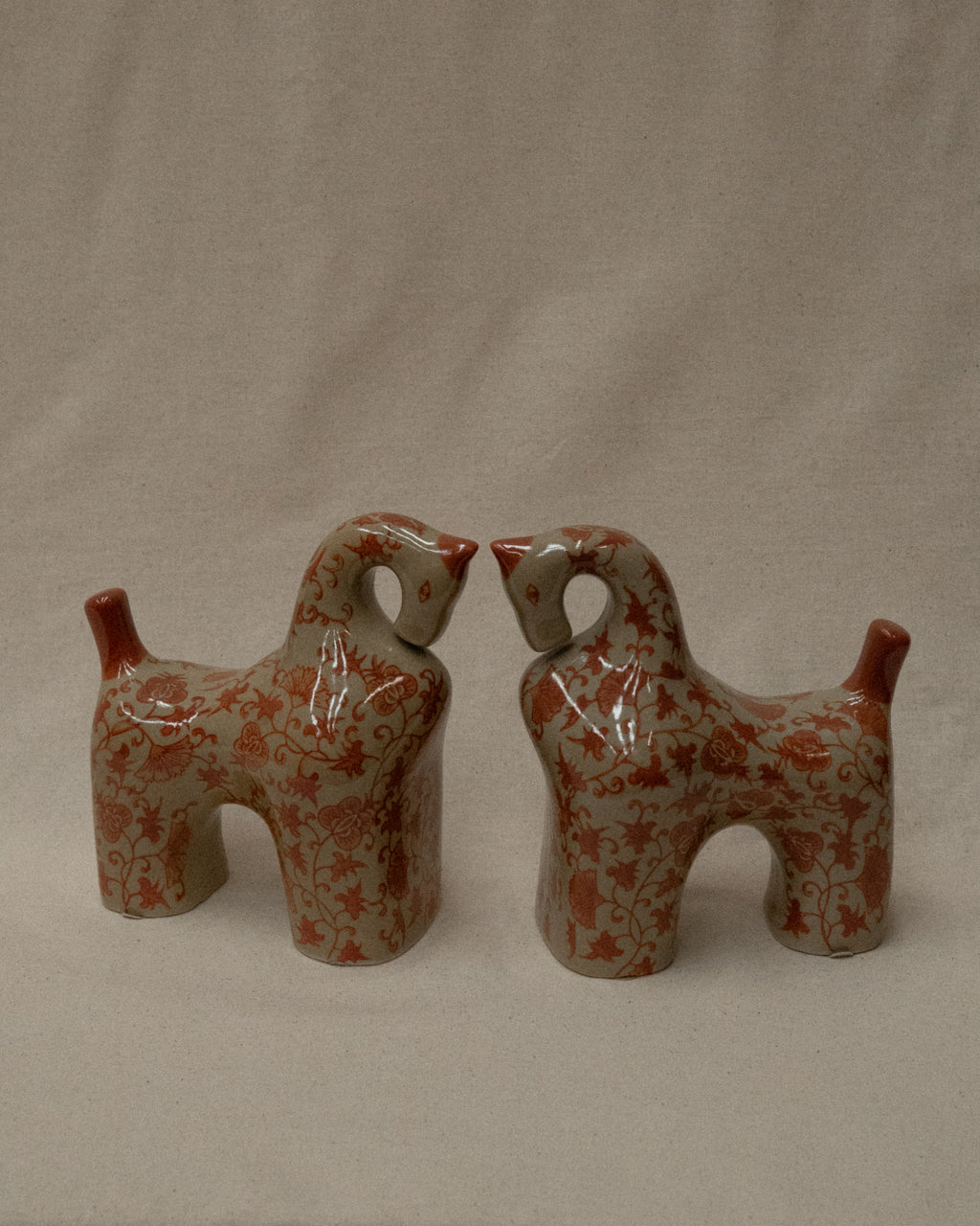 Pair of ceramic horses in pink and brown