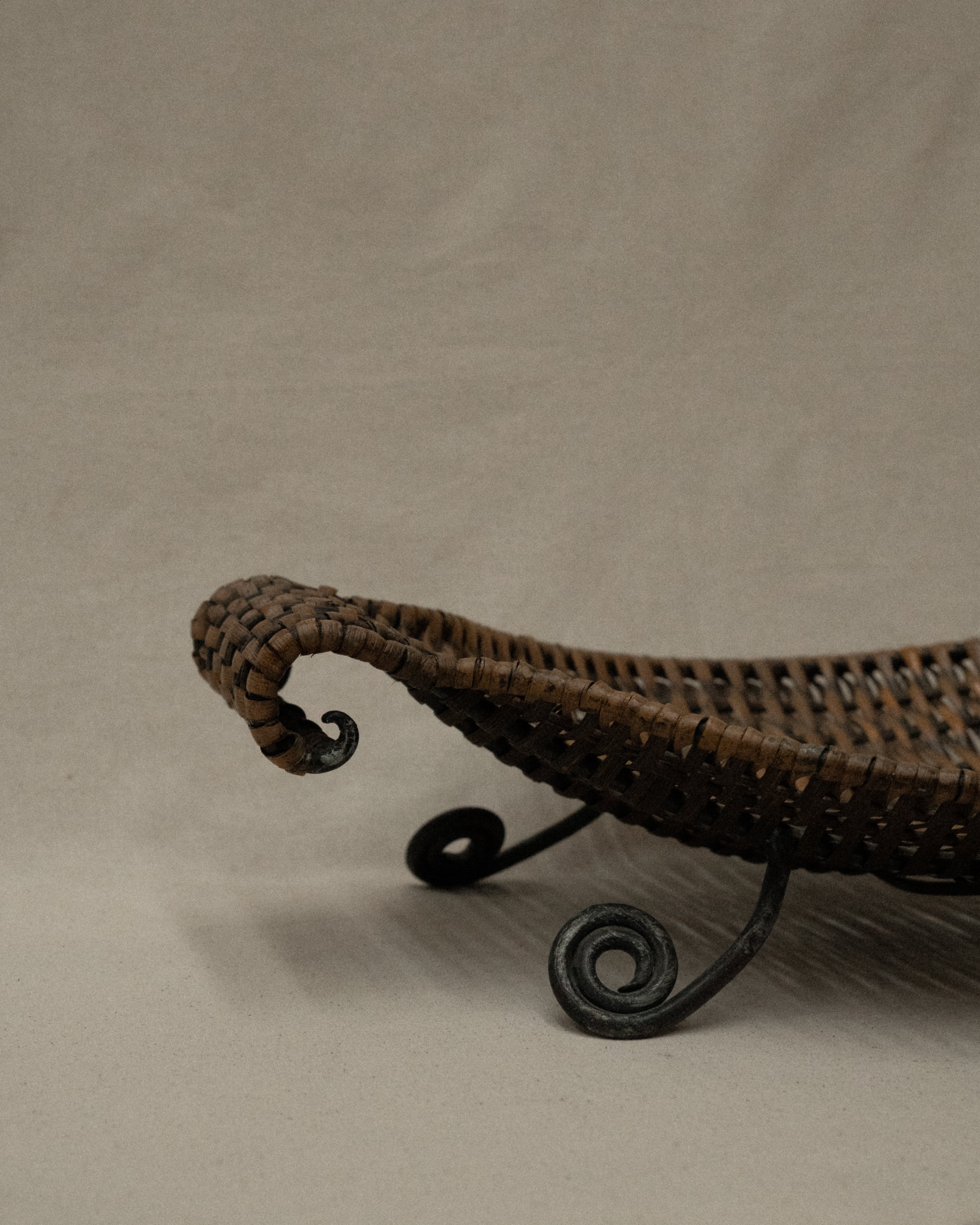 Woven bowl with metal frame and spiral feet
