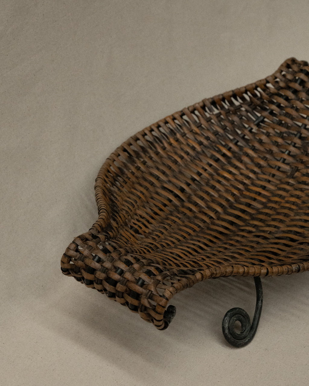 Woven bowl with metal frame and spiral feet