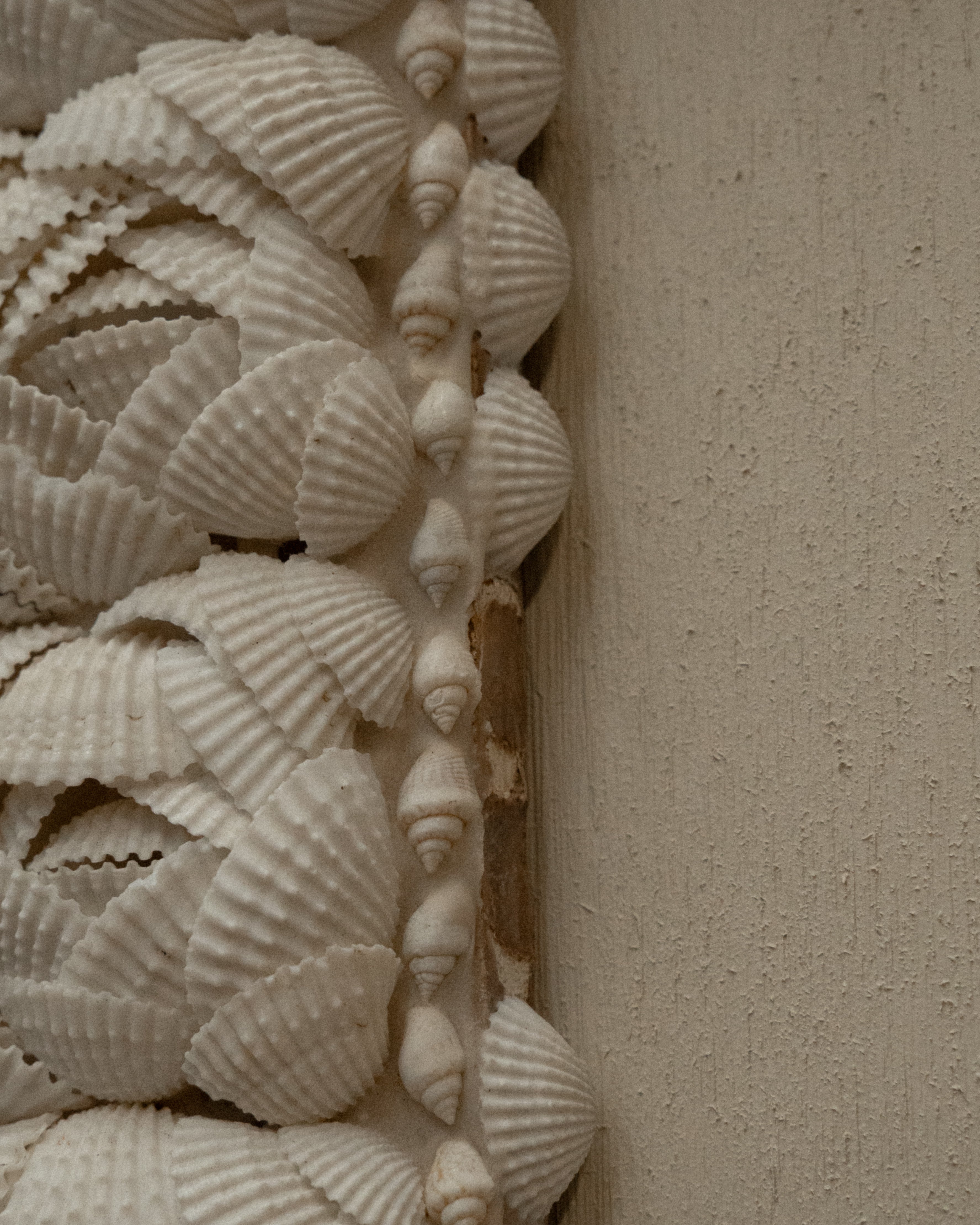 Cross wall hanging decorated with shells