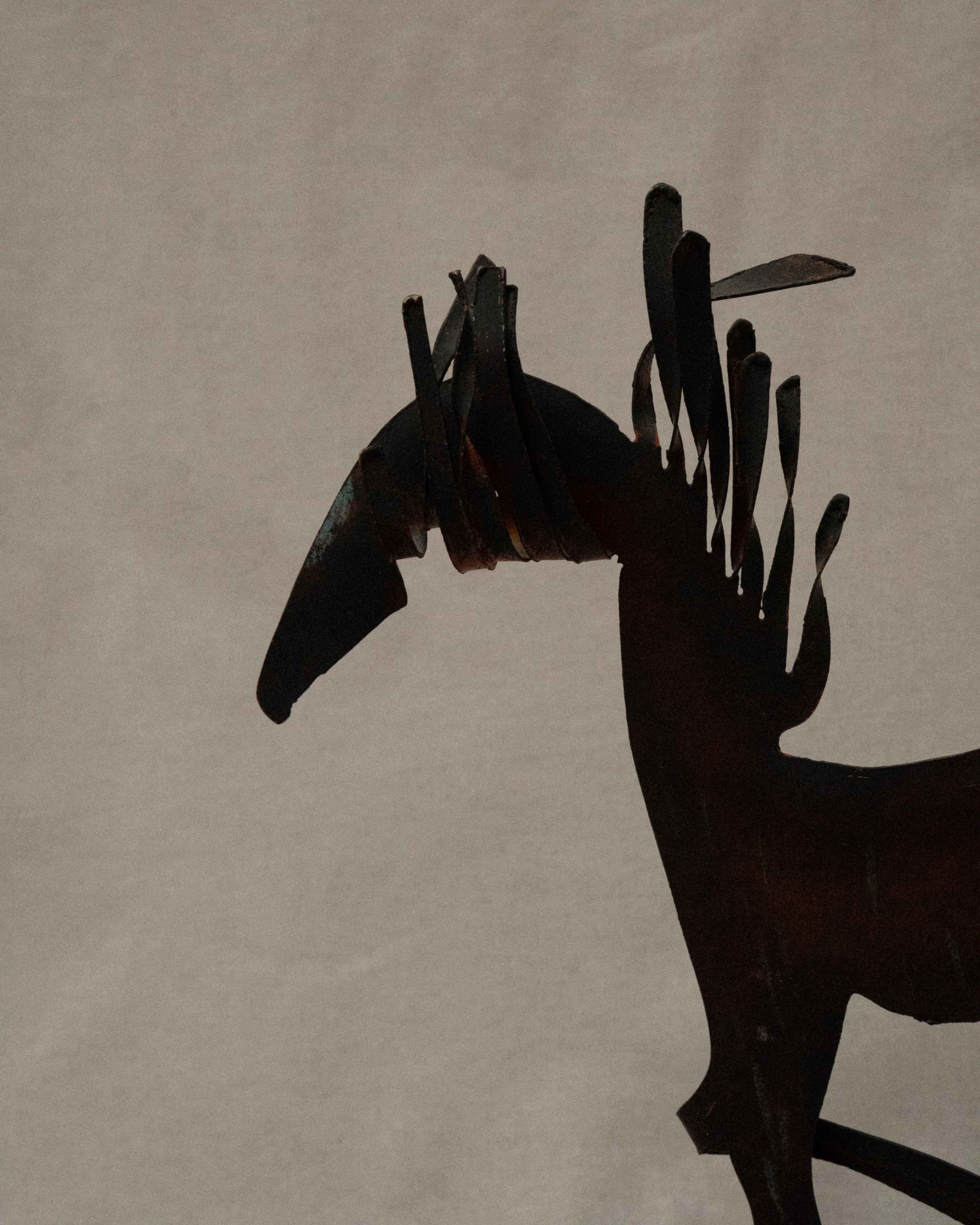 Brutalist metal horse sculpture with intentional patina