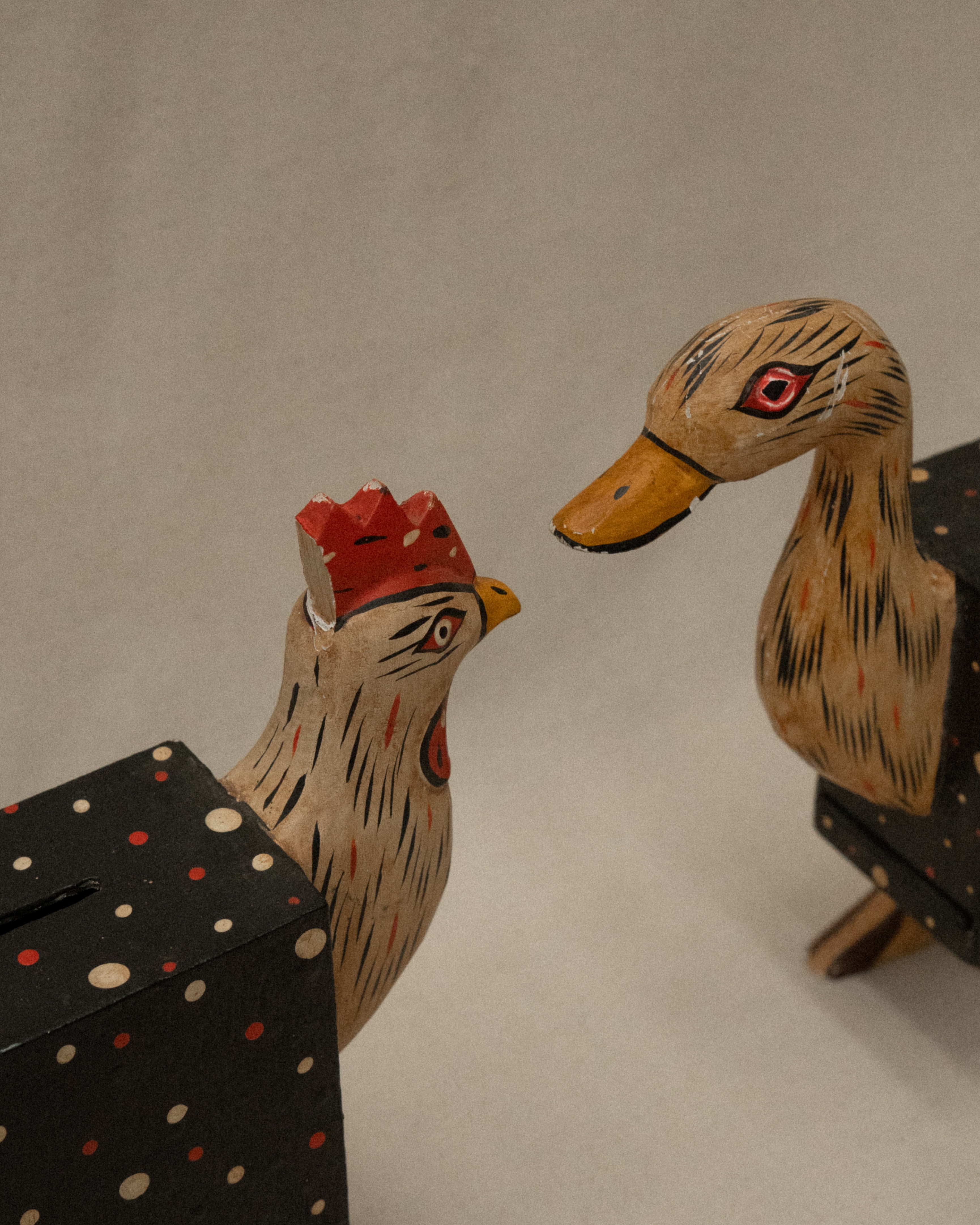 Pair of painted wooden chicken and duck coin box