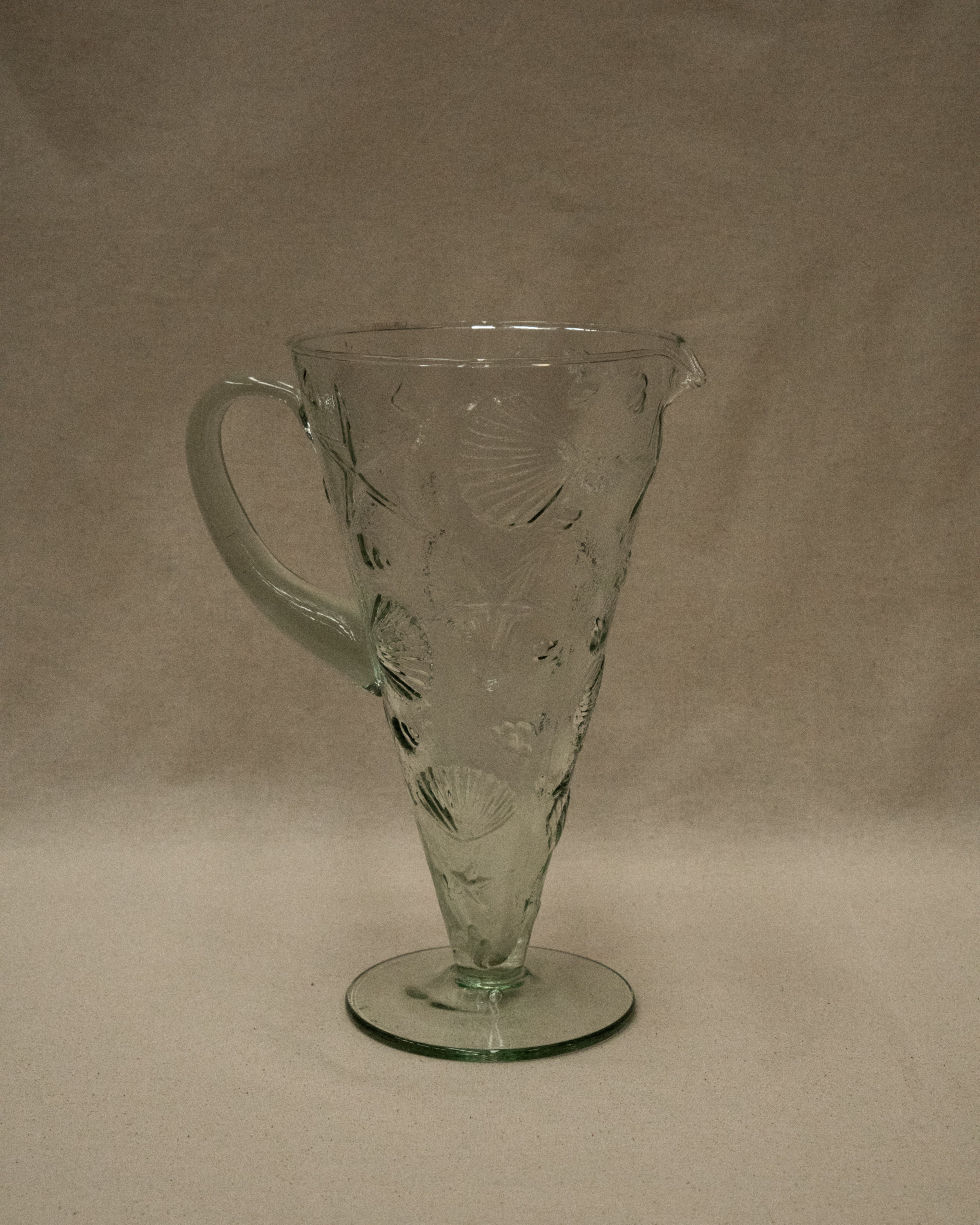 Glass pitcher with embossed seashells