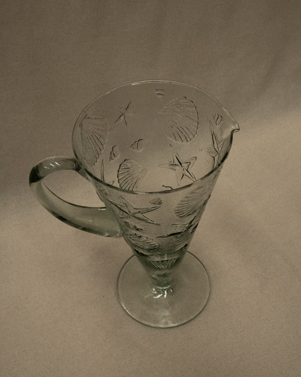 Glass pitcher with embossed seashells