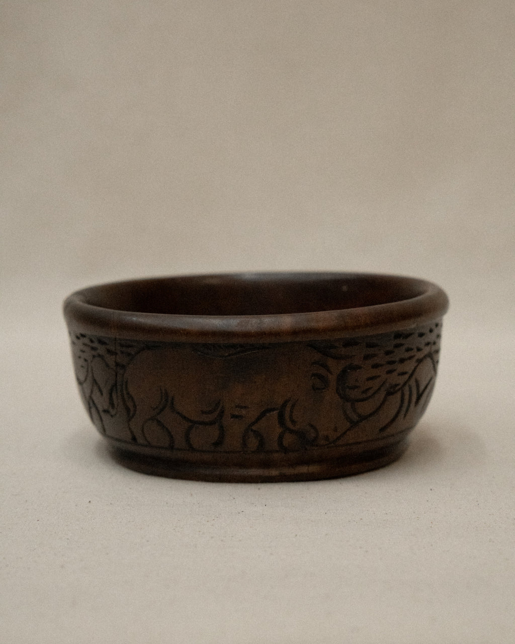 Solid handcarved wooden bowl with rhino engravings