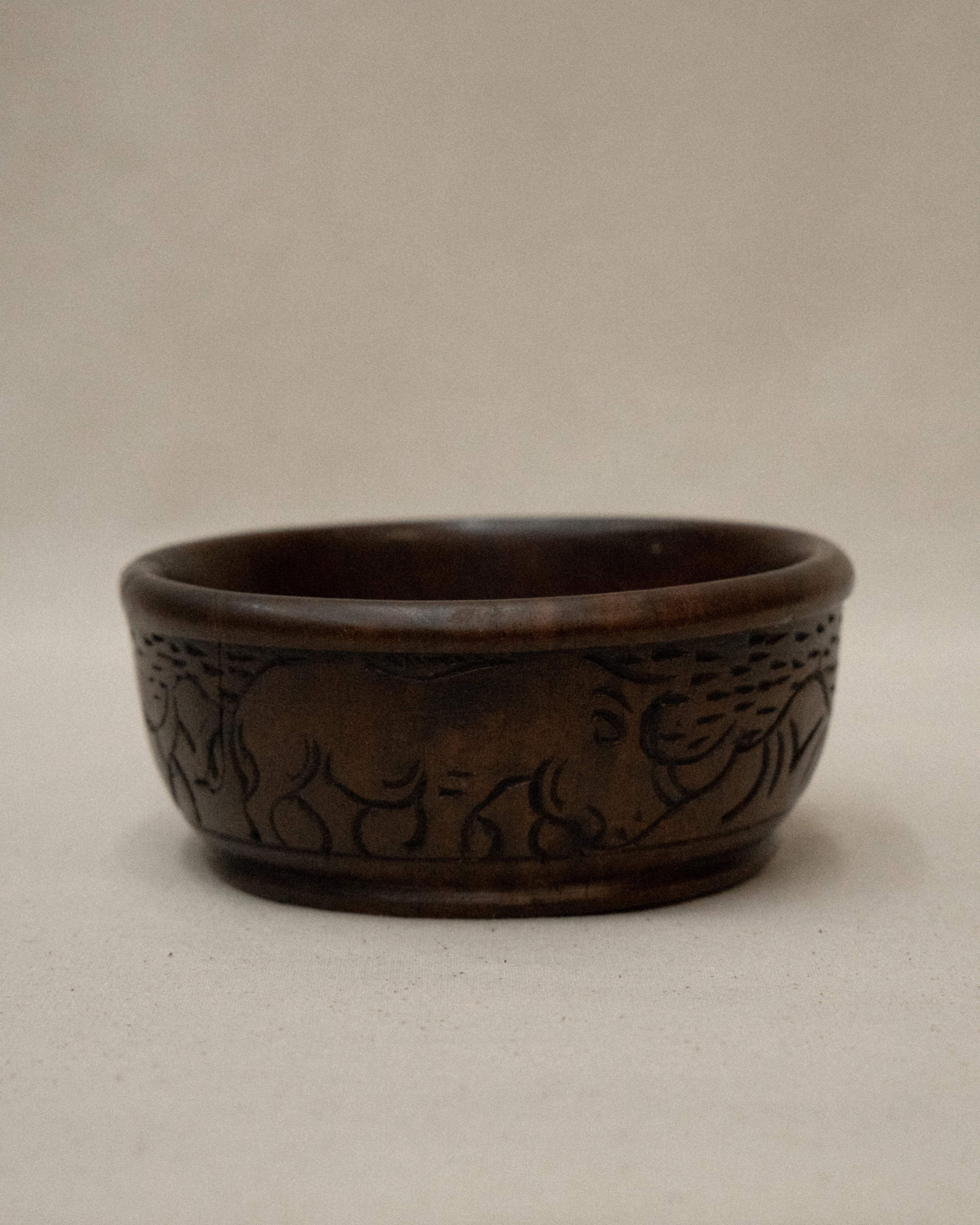 Solid handcarved wooden bowl with rhino engravings