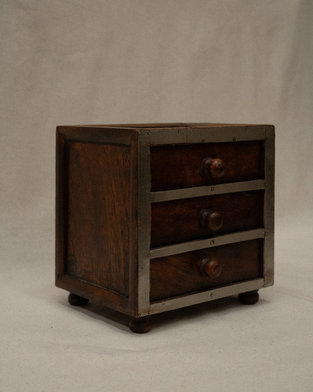 Wooden box with metal front and three drawers