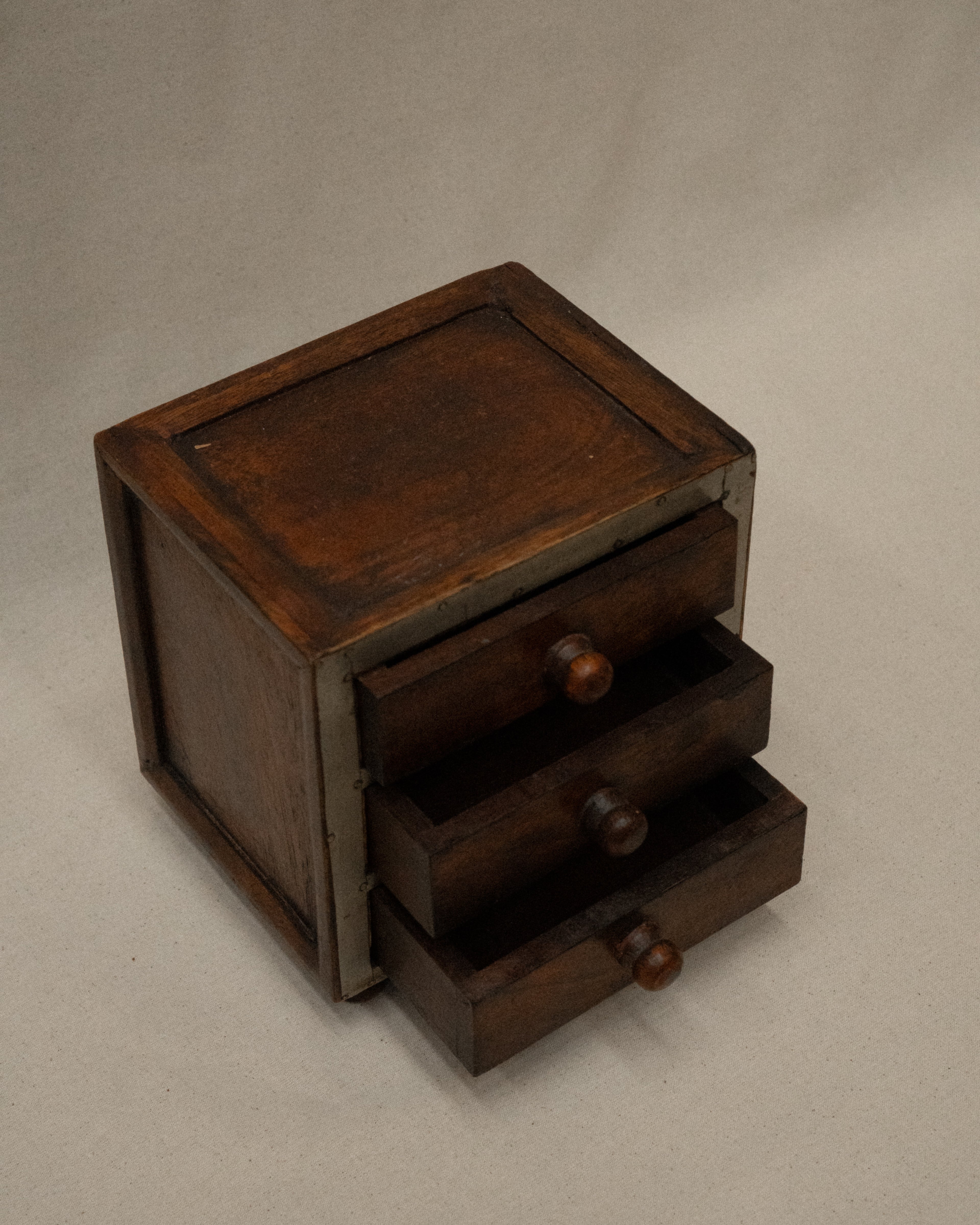 Wooden box with metal front and three drawers