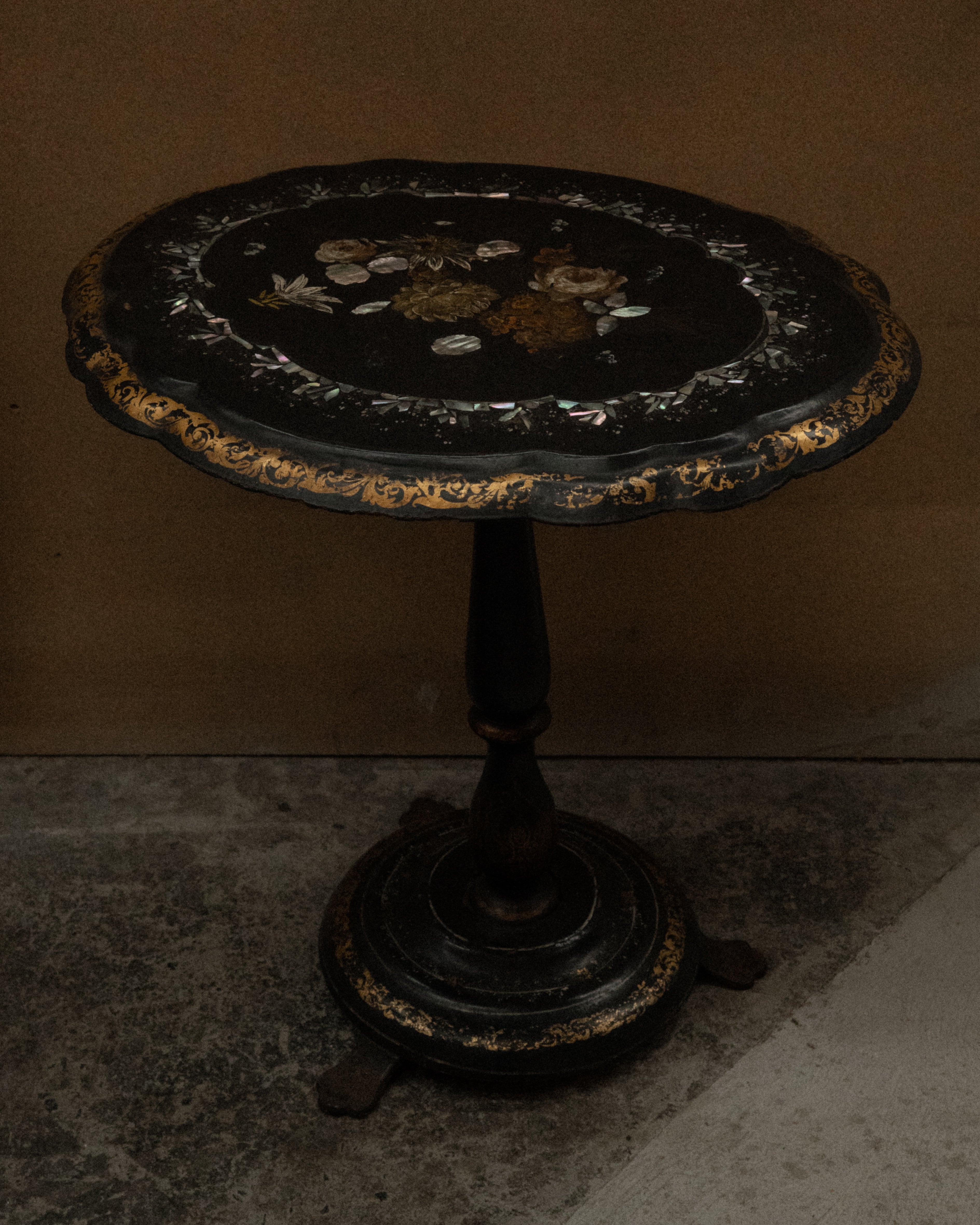 Paper mache and mother of pearl inlaid table likely made between mid to late 19th century
