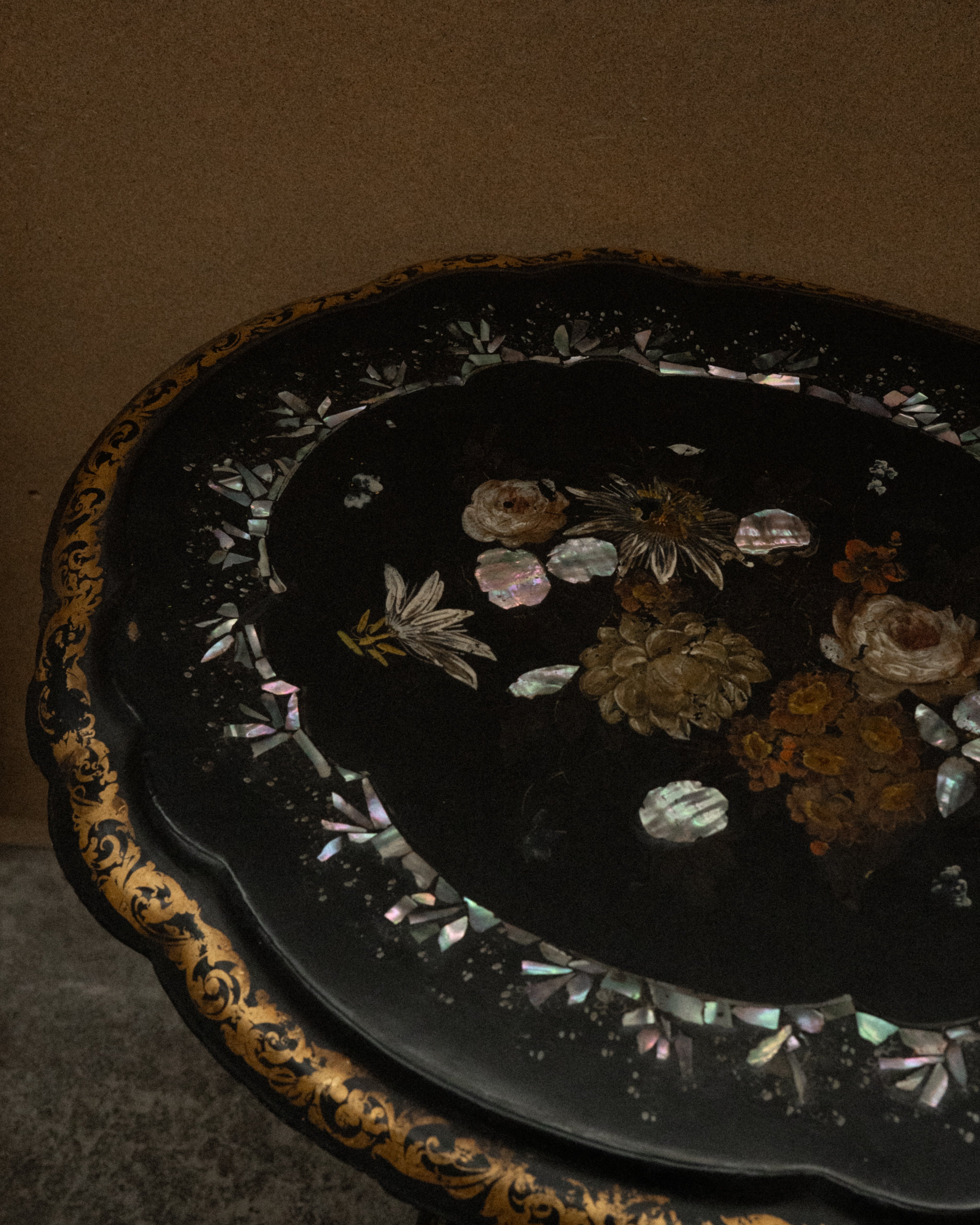 Paper mache and mother of pearl inlaid table likely made between mid to late 19th century