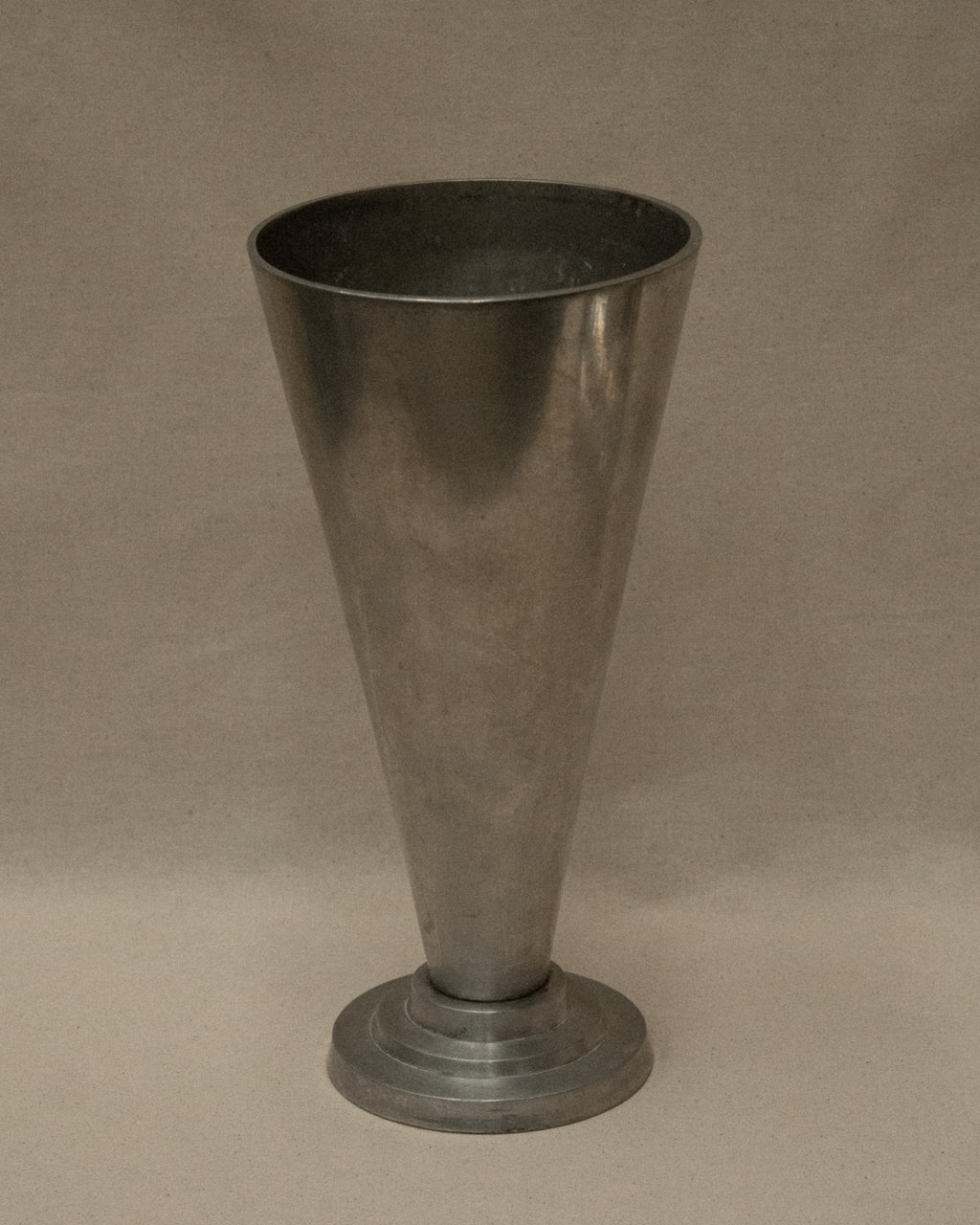 Art deco style conical footed aluminum vase