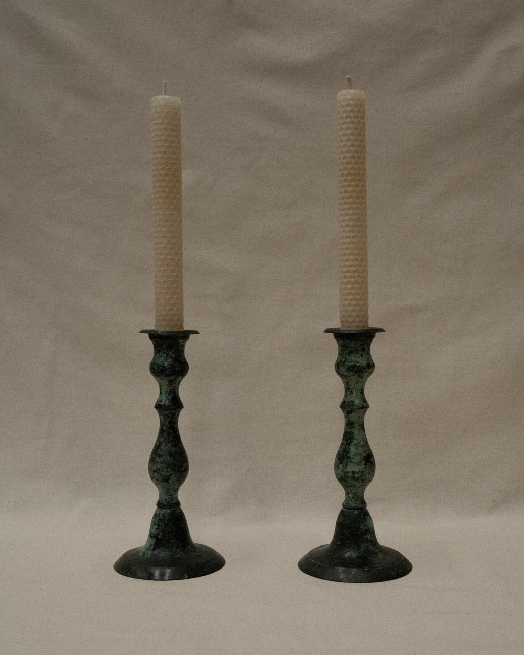 Pair of intentional verdigris candle holders