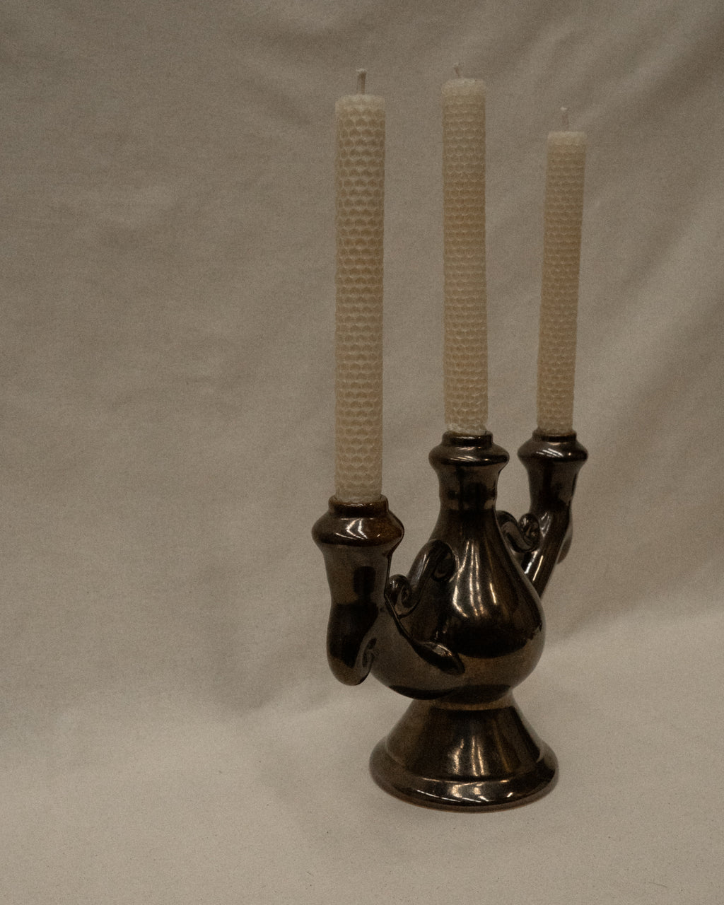Ceramic candelabra with a reflective brown glaze