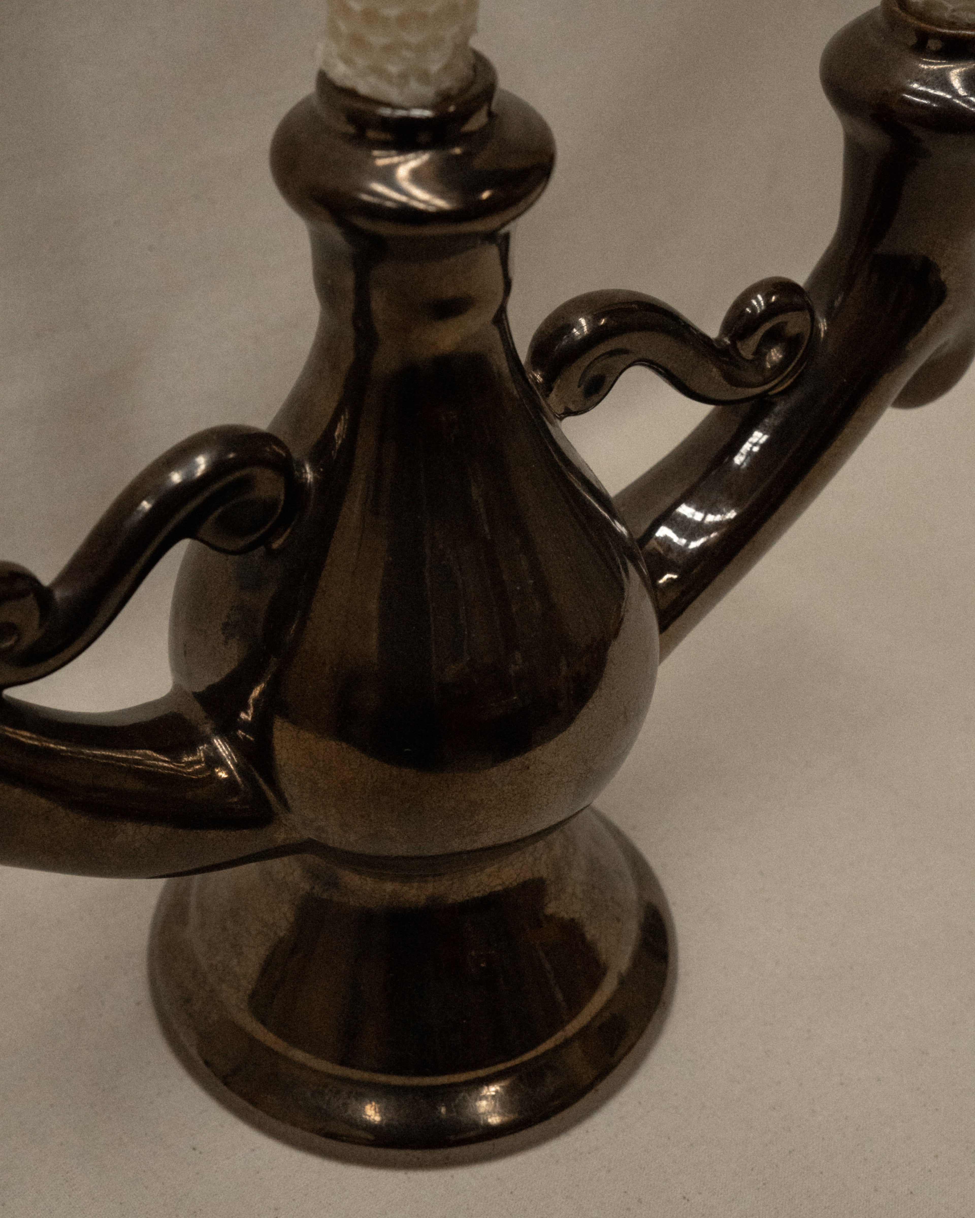 Ceramic candelabra with a reflective brown glaze