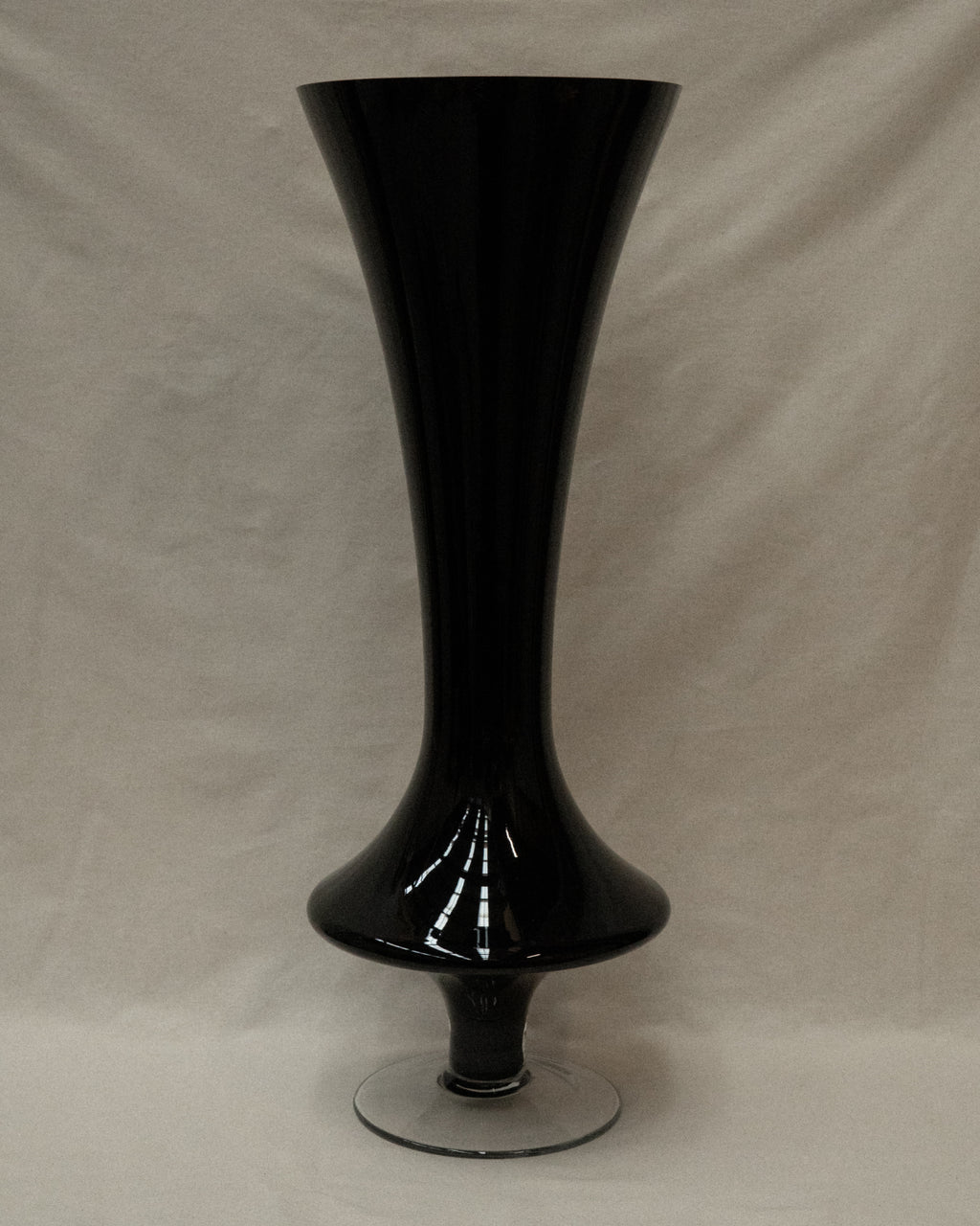 Black opaque art glass vase with transparent base
