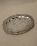 Metal tray with temple and tree engravings on feet