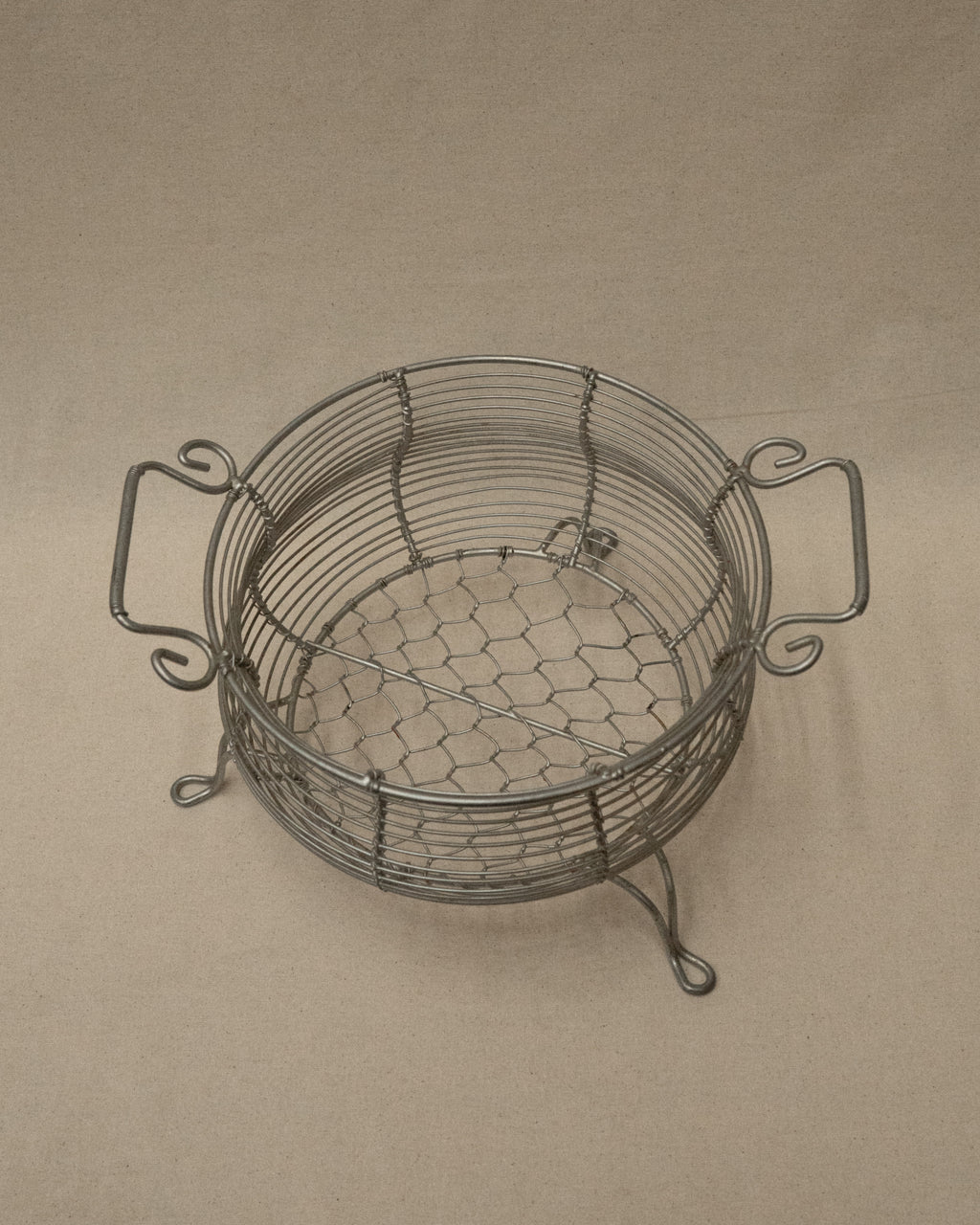 Wire metal basket with two handles and feet
