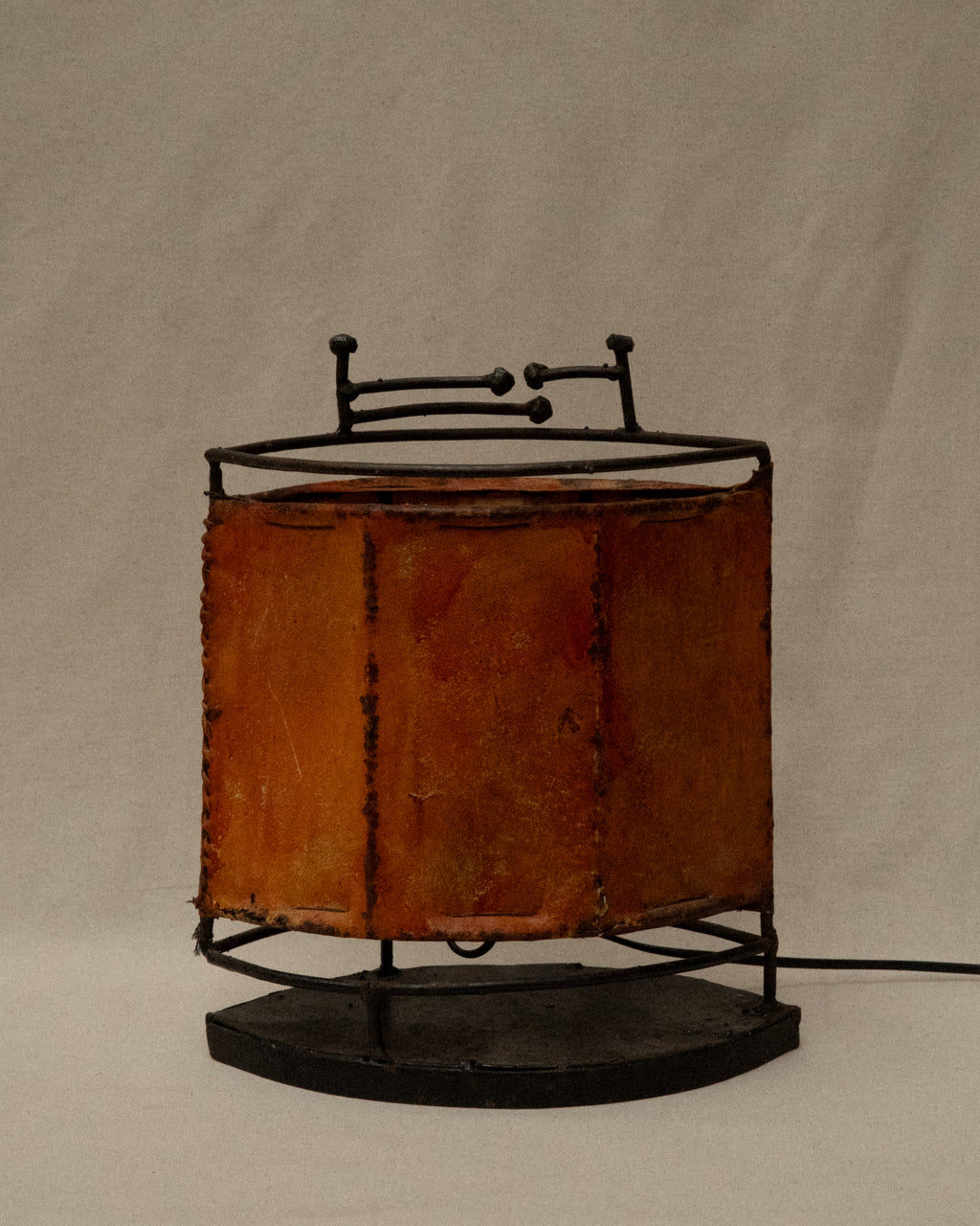 Wrought iron and stained goat hide lamp