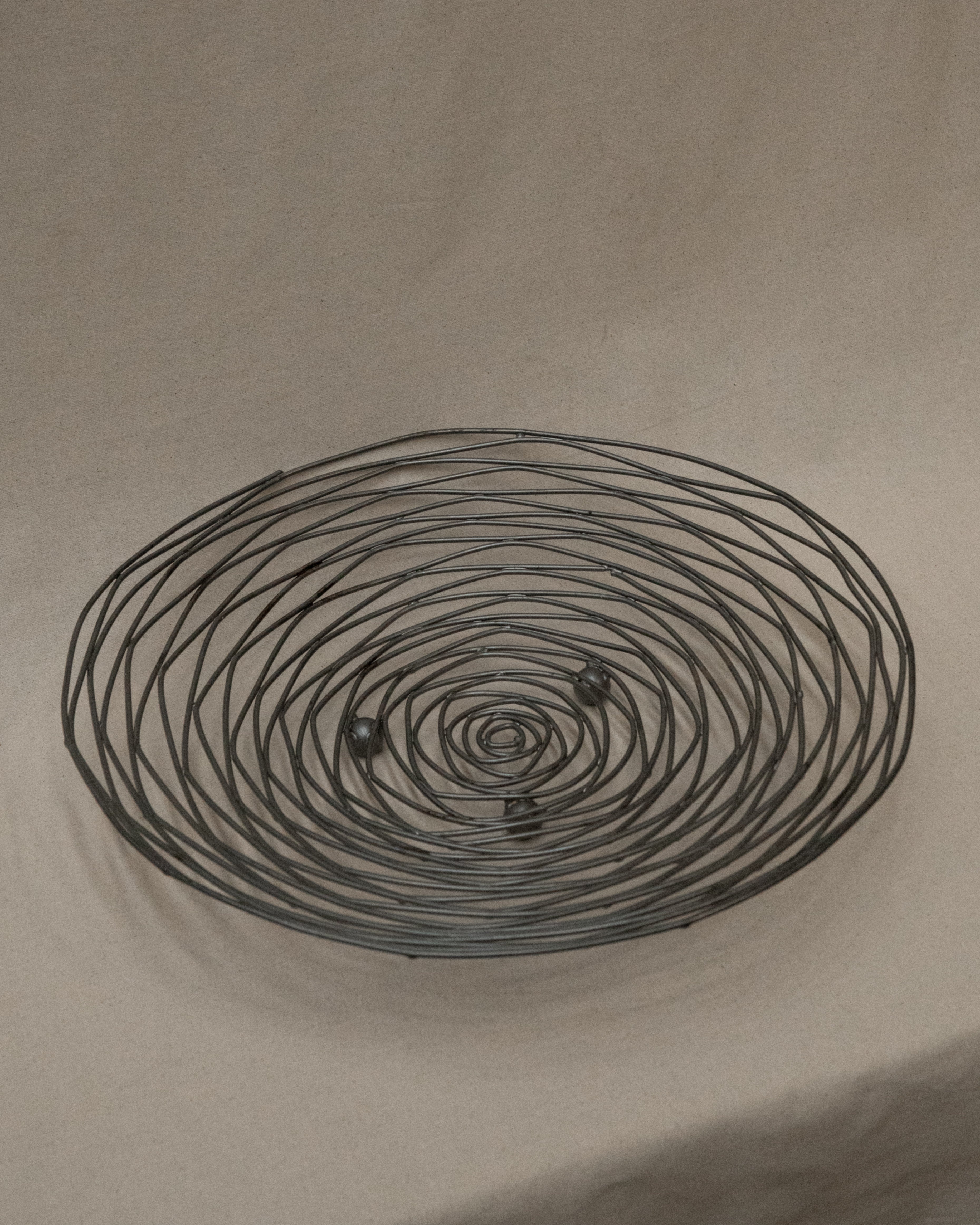 Shallow large wire like metal bowl with round soldering details