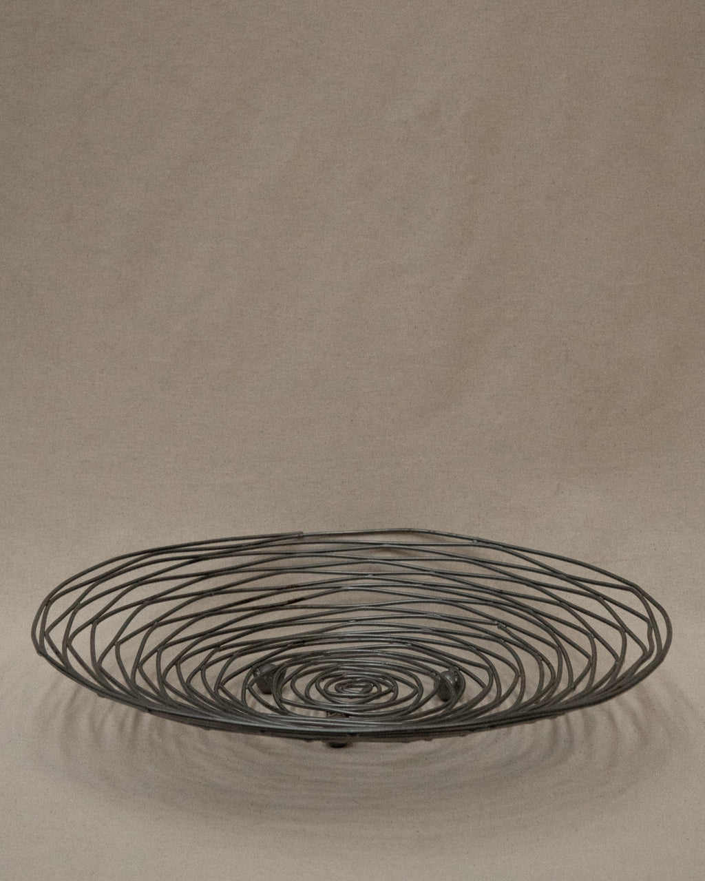 Shallow large wire like metal bowl with round soldering details