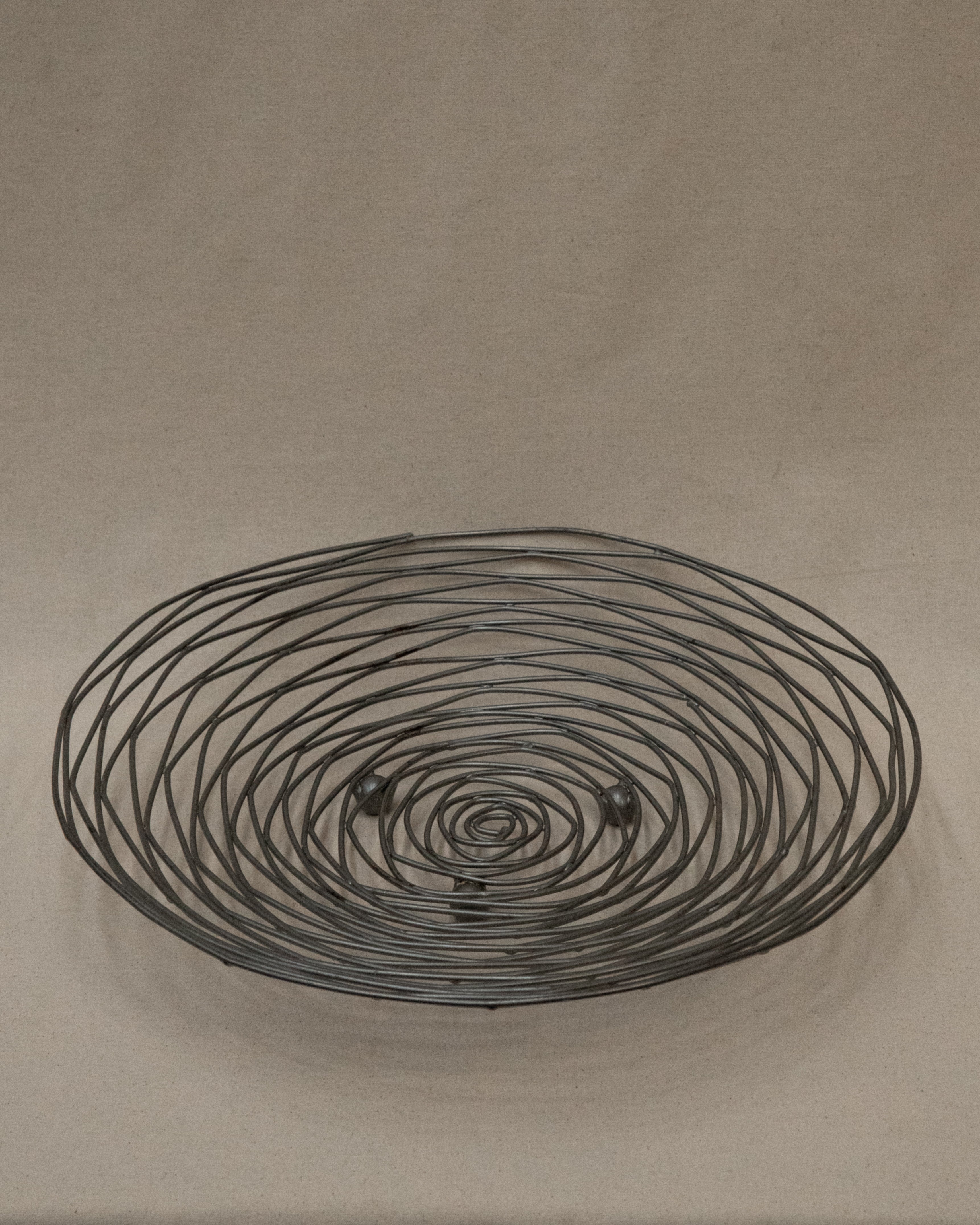 Shallow large wire like metal bowl with round soldering details
