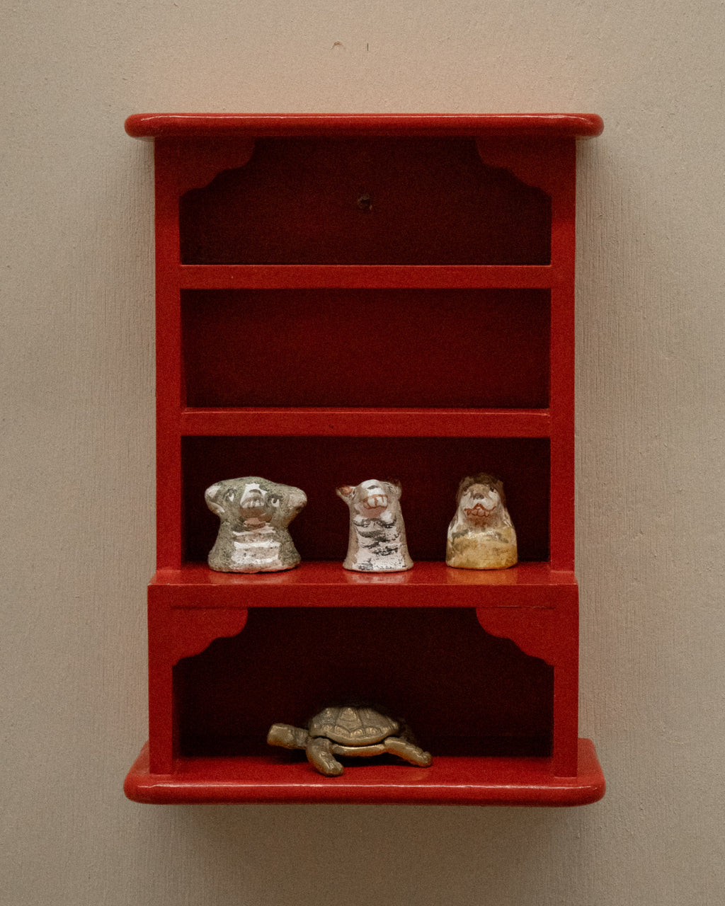 Orange red painted wooden trinket display shelf