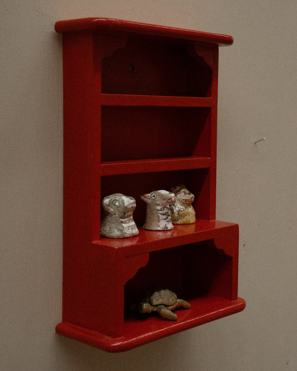 Orange red painted wooden trinket display shelf
