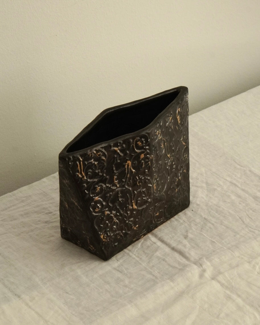 Black ceramic vase with gold accents