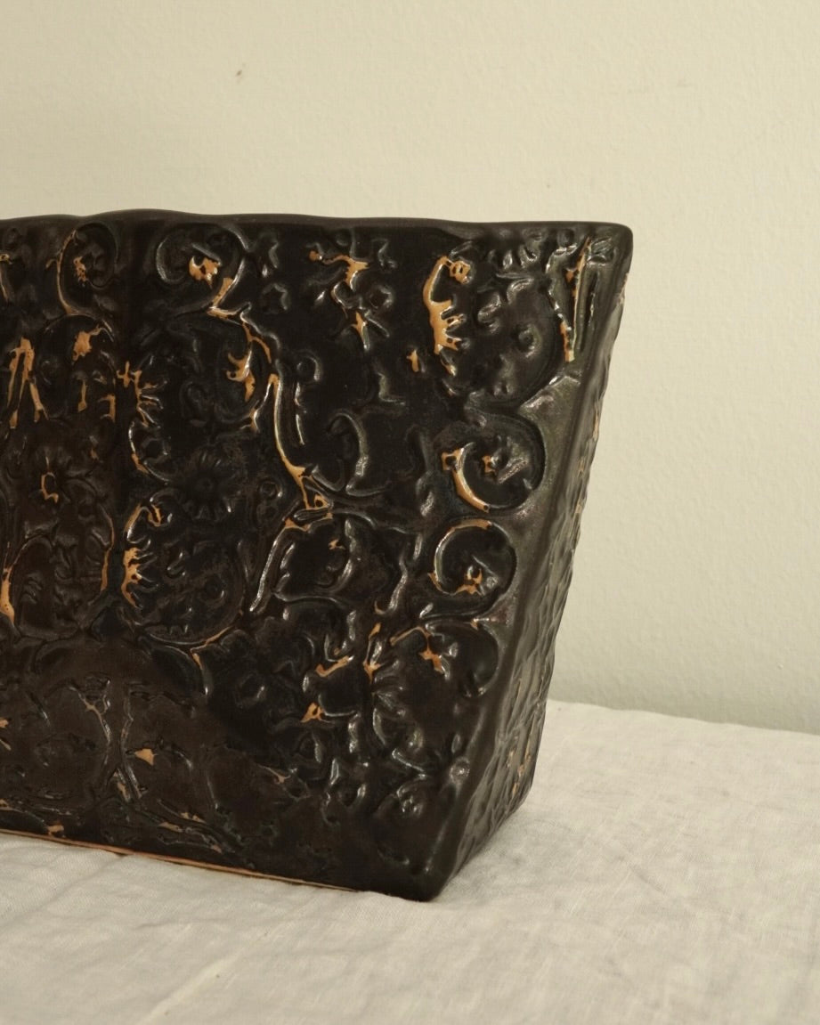 Black ceramic vase with gold accents