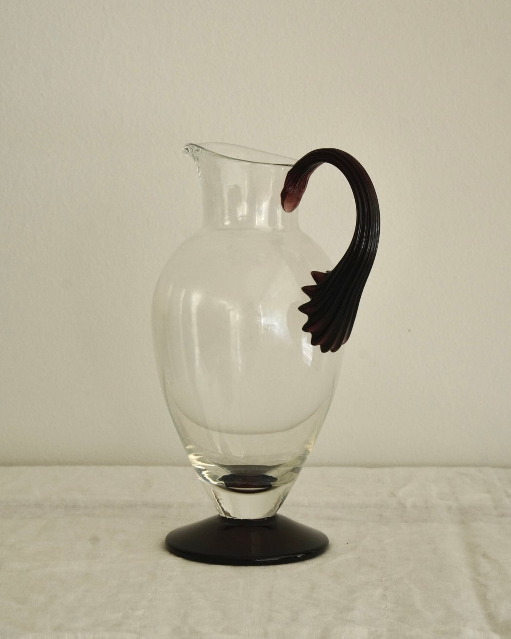 Glass pitcher vase with star like dark purple handle