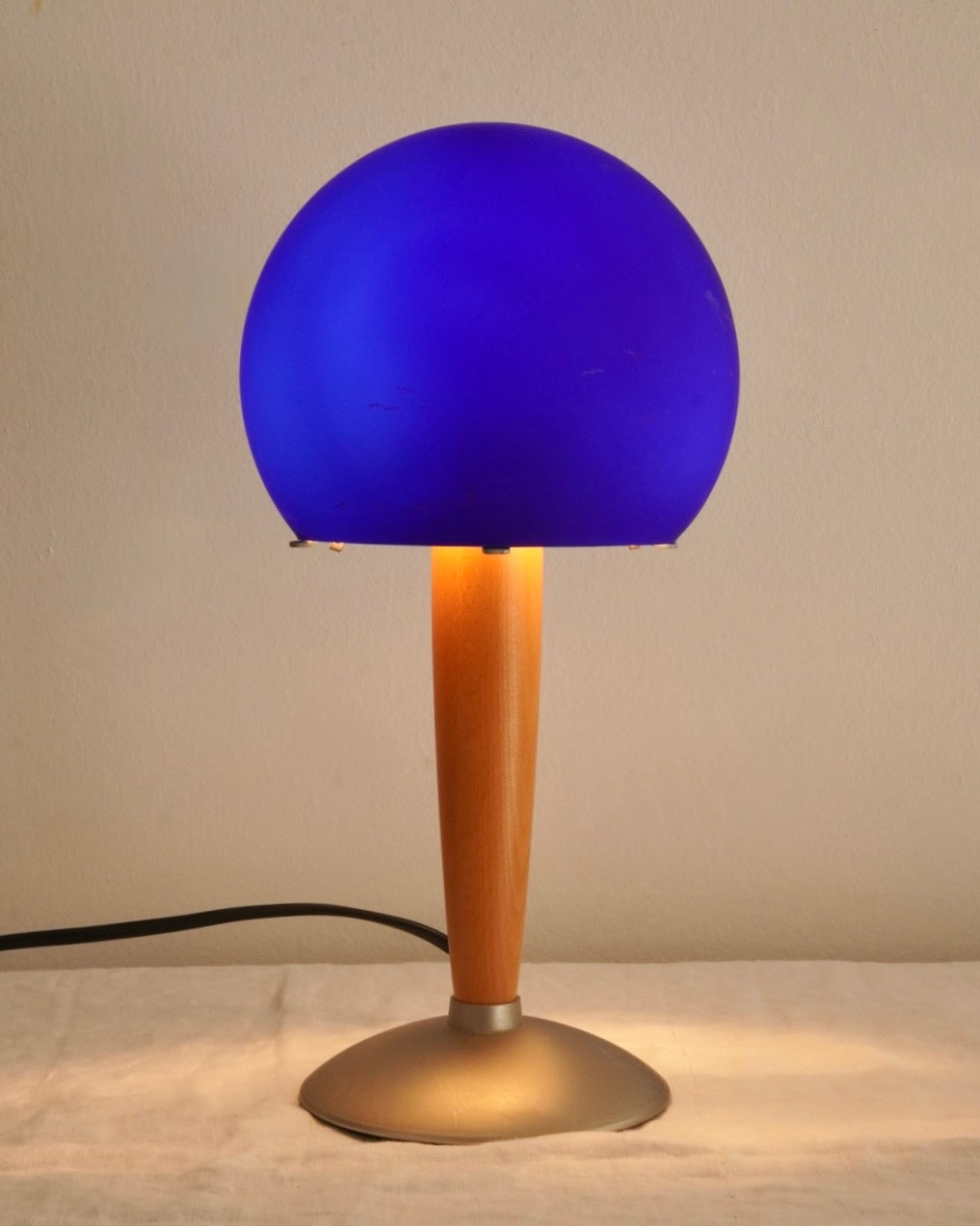 Art deco blue glass lamp with wooden and metal base