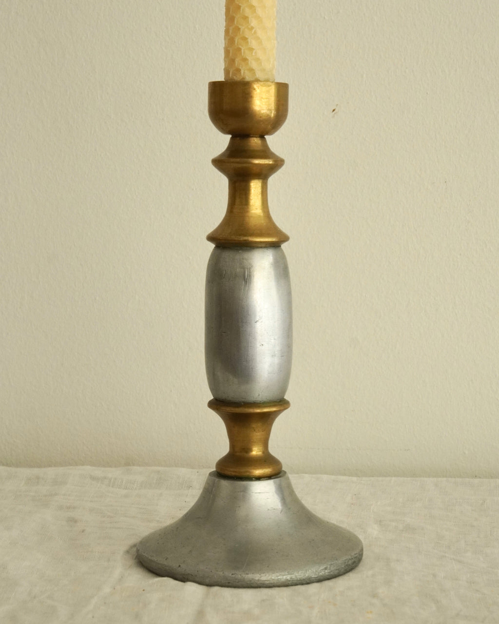 Pair of solid metal candle holders in gold and silver