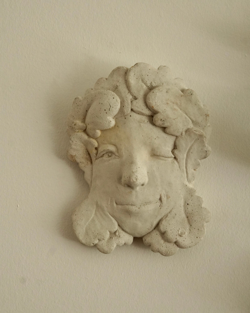 Winking concrete lady wall hanging