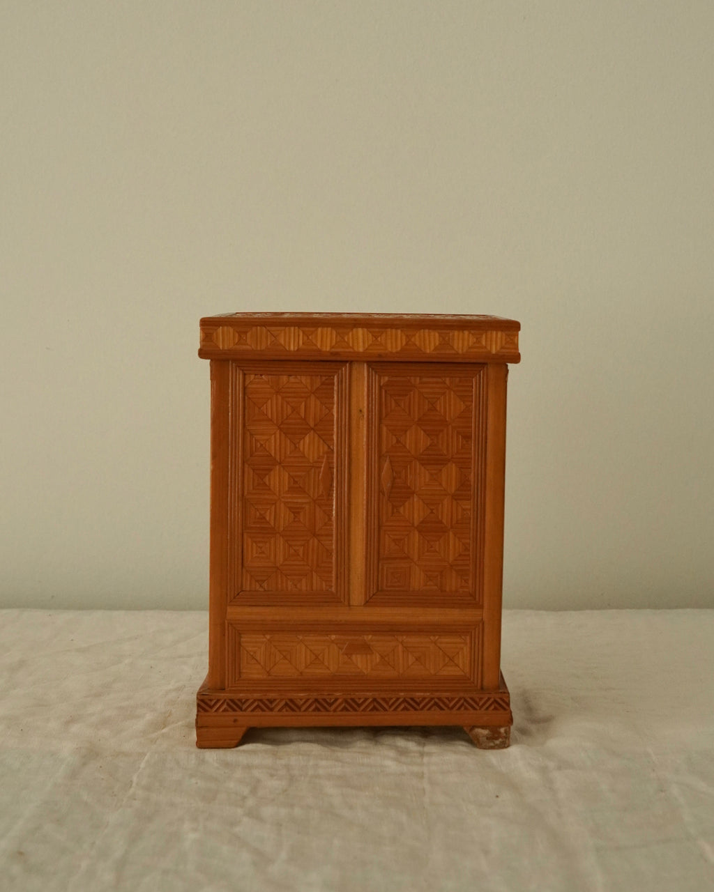 Tramp art storage box in the design of a wardrobe