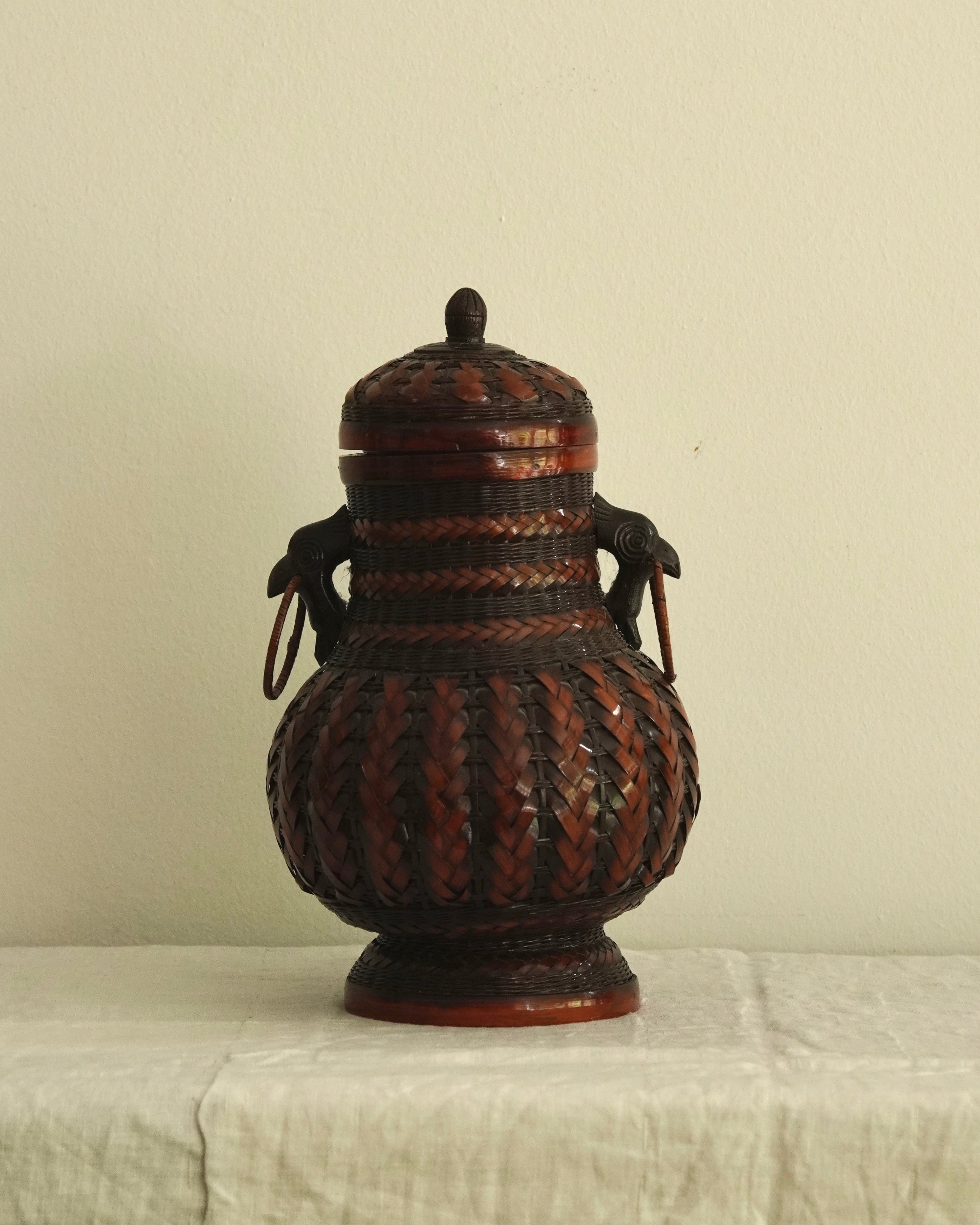 Woven basket with lid, carved wood bird handles and copper vase insert