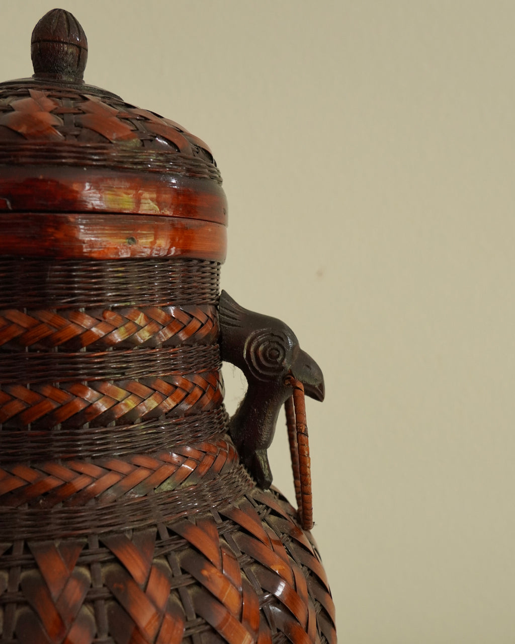 Woven basket with lid, carved wood bird handles and copper vase insert