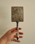 Silver handheld mirror with silk backing