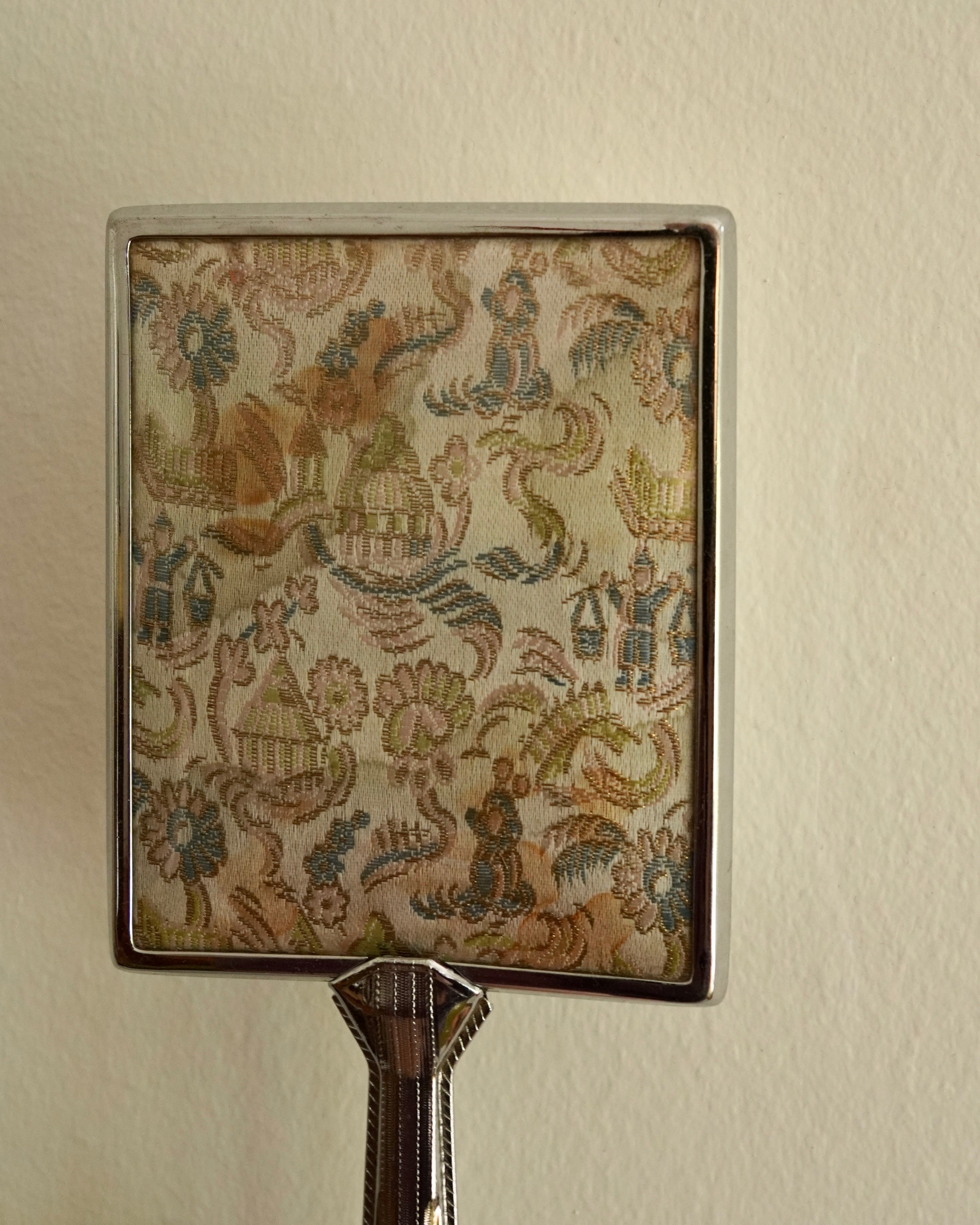 Silver handheld mirror with silk backing