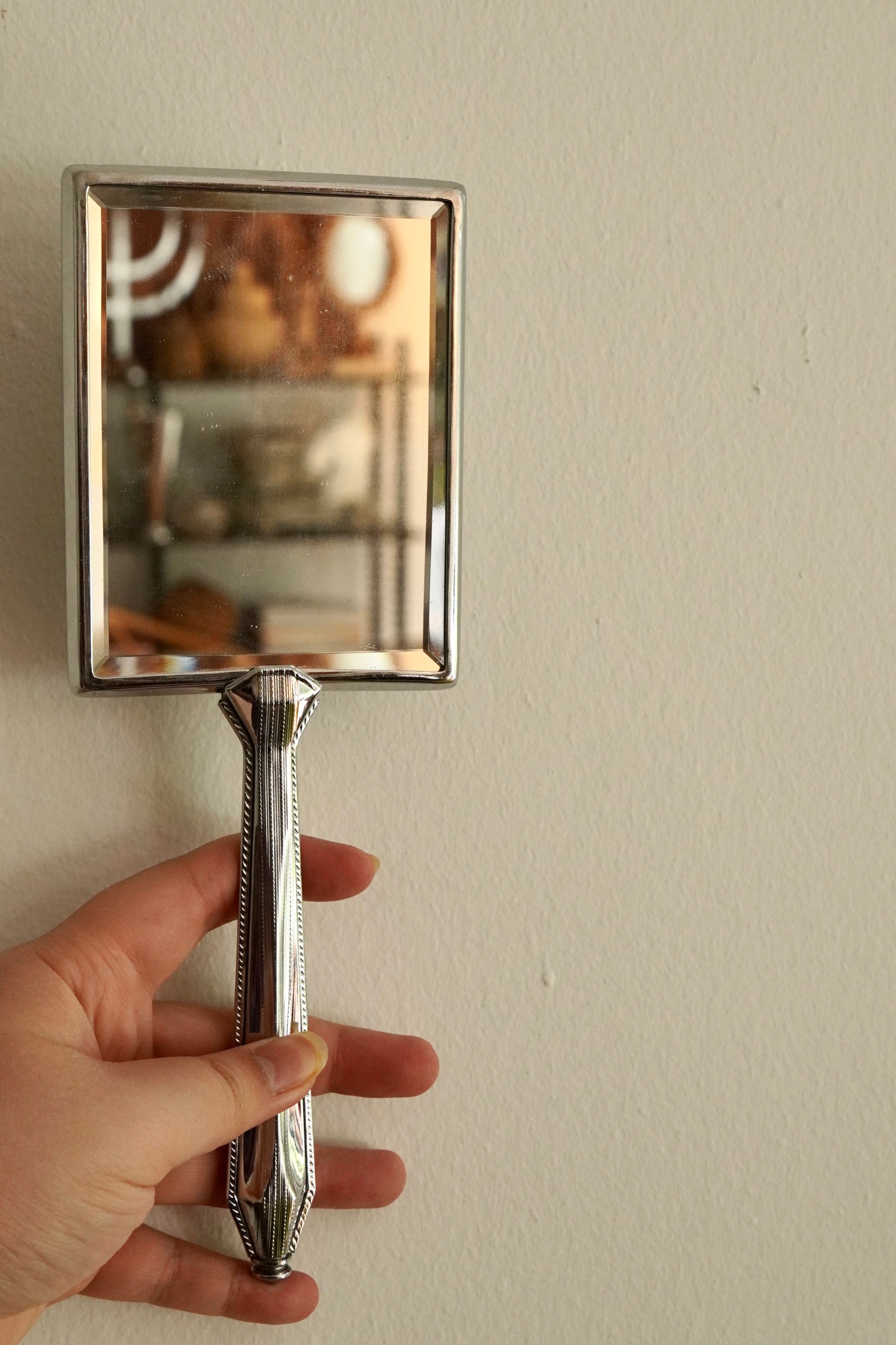 Silver handheld mirror with silk backing