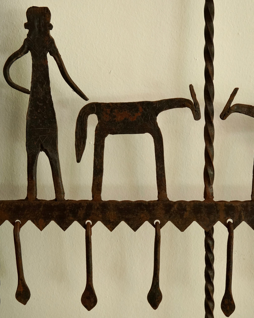 Ethnographic wall mounted panel featuring wrought iron animal and human figures