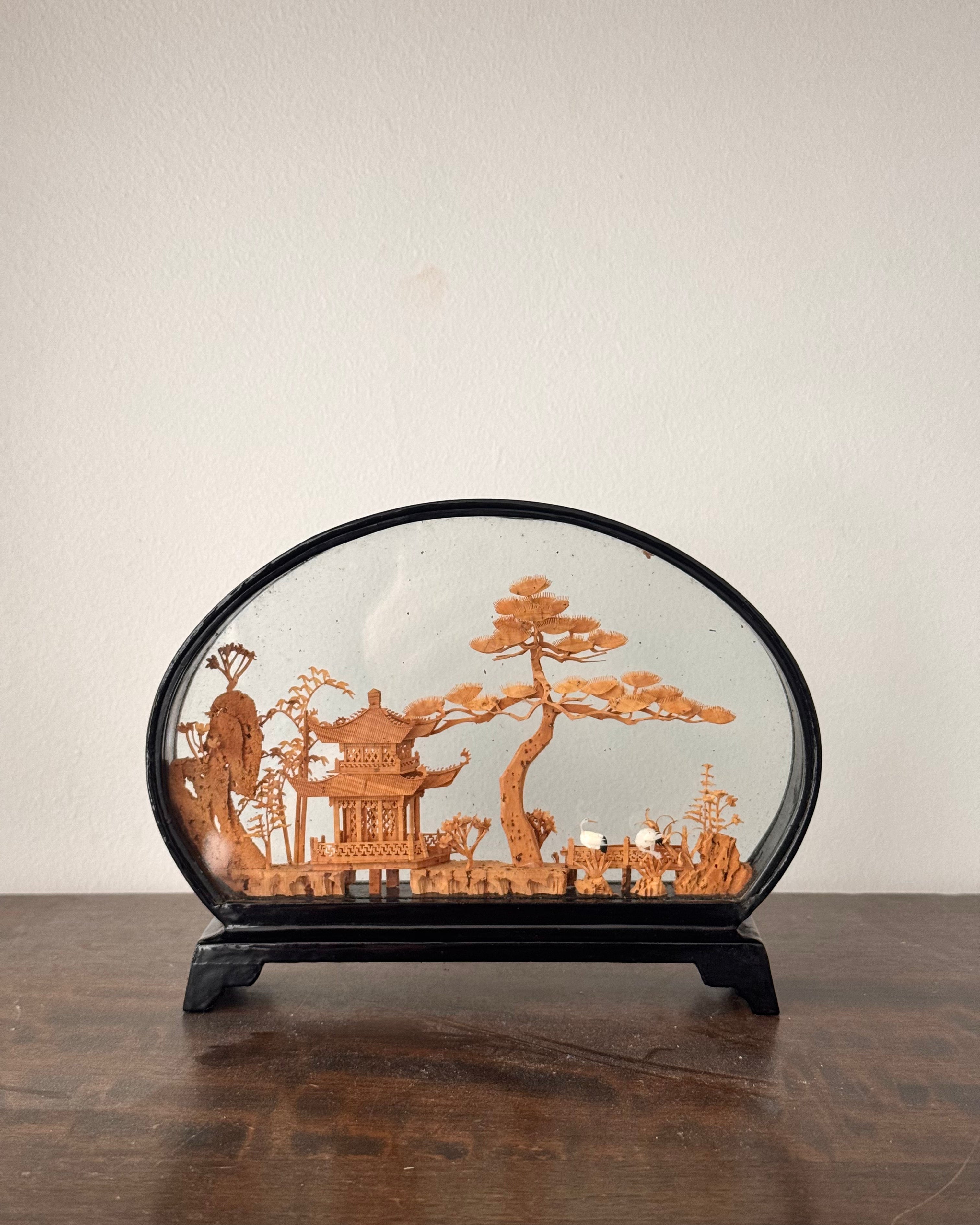Chinese hand carved diorama feauturing a pagoda and stalks (oval)
