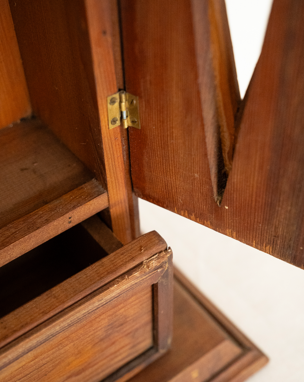 Wooden gothic style cabinet with shelving, two doors and a drawer